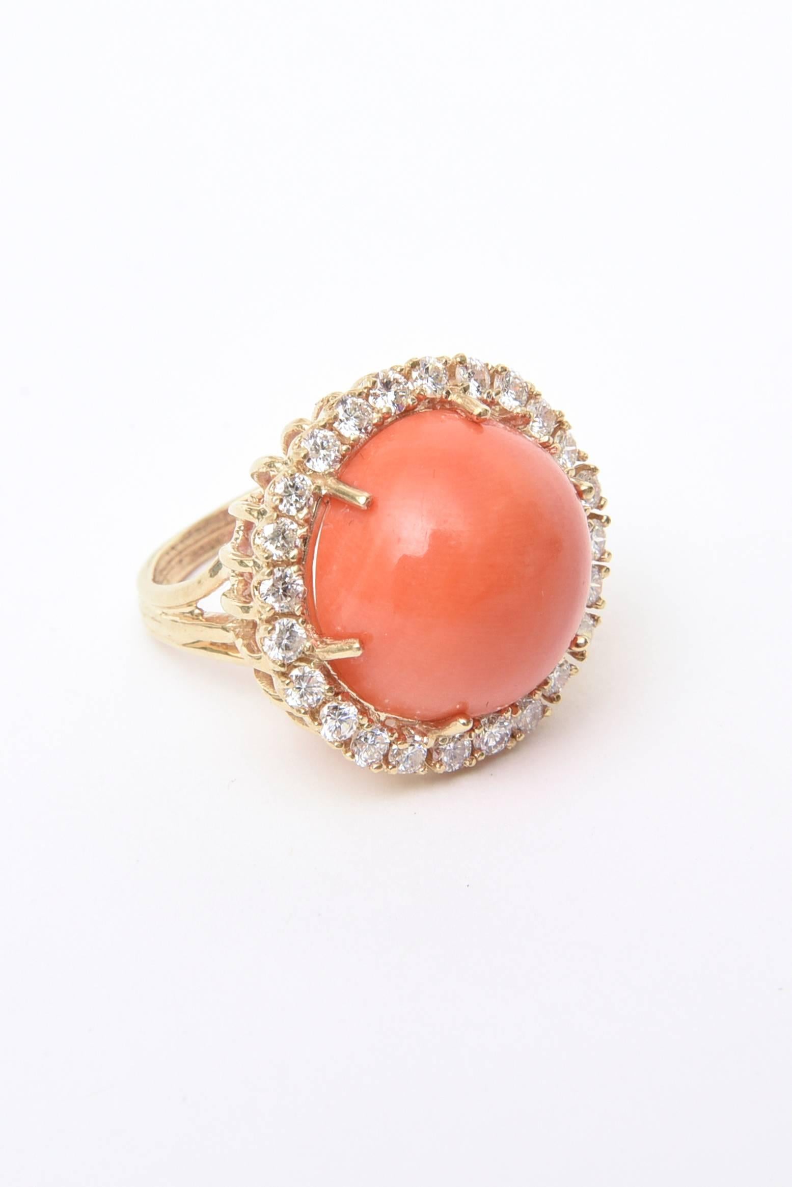 This impressive cabochon cut gorgeous angel skin coral is pronged set surrounded by approximately 25-26 diamonds of VS-Si clarity and GH color. It is set on the sides in a basket weave design o f14K yellow gold.
This lovely dome cocktail ring is