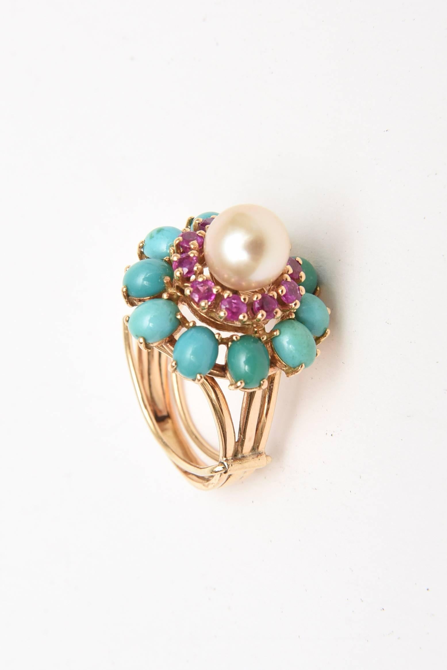 This lovely dome cocktail ring of 14K yellow gold has 10 oval cabochon cut turquoise stones prong set that are preceded by 10 ruby stones of 2.4 millimeter each. The cultured pearl is in the center. It is 7.2 DWT. The ring size is 6.5. This is from