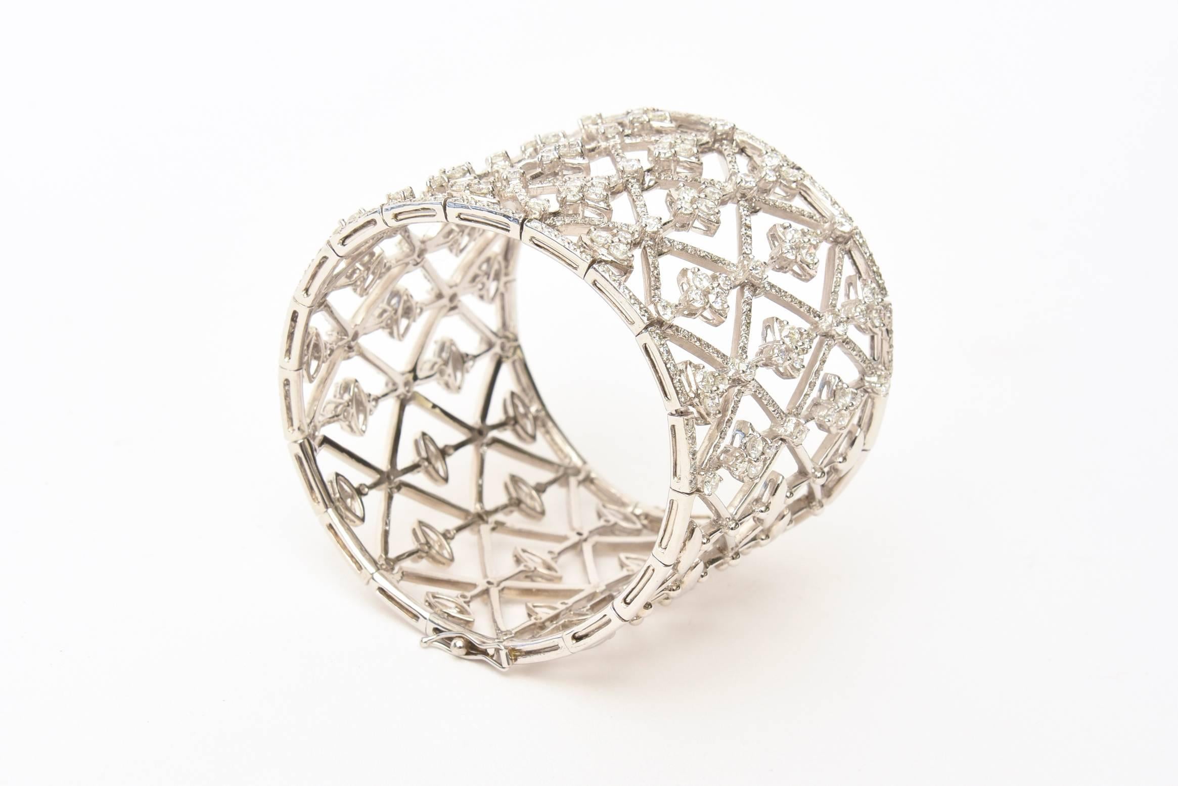 This gorgeous Italian wide cuff bracelet is18 K white gold that contains 473 pave set round brilliant cut diamonds that weigh approx 8.90 carat total.It has a lovely geometric pattern. 
It has f/g color and cvs/vs clarity. bracelet weighs 66