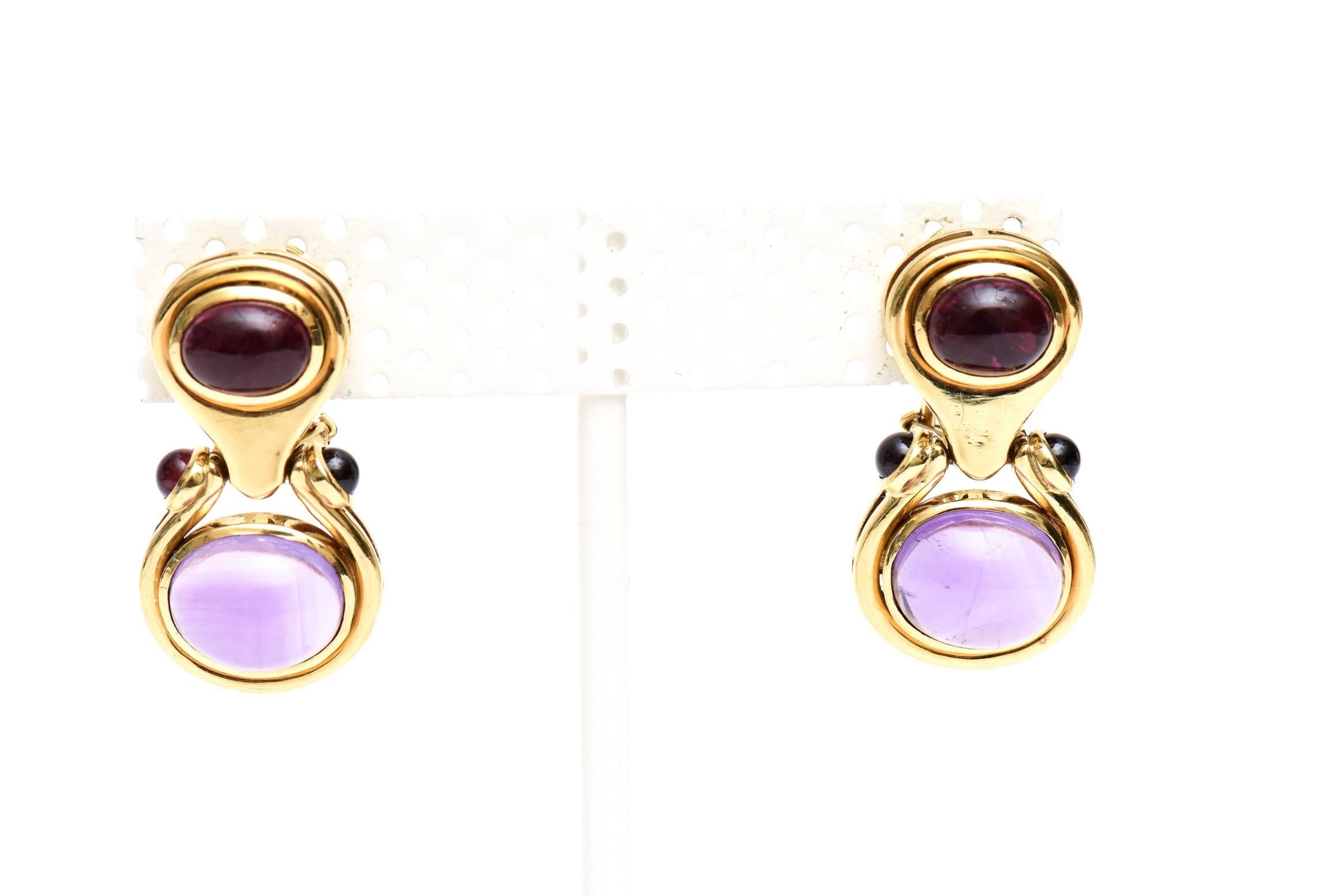 These beautiful and classic pair of drop/dangle vintage 18 Karat Yellow Gold drop  pierced earrings have gorgeous cabochon siberian amethyst stones. The color is the same on top and sides although it has photographed differently. it looks darker