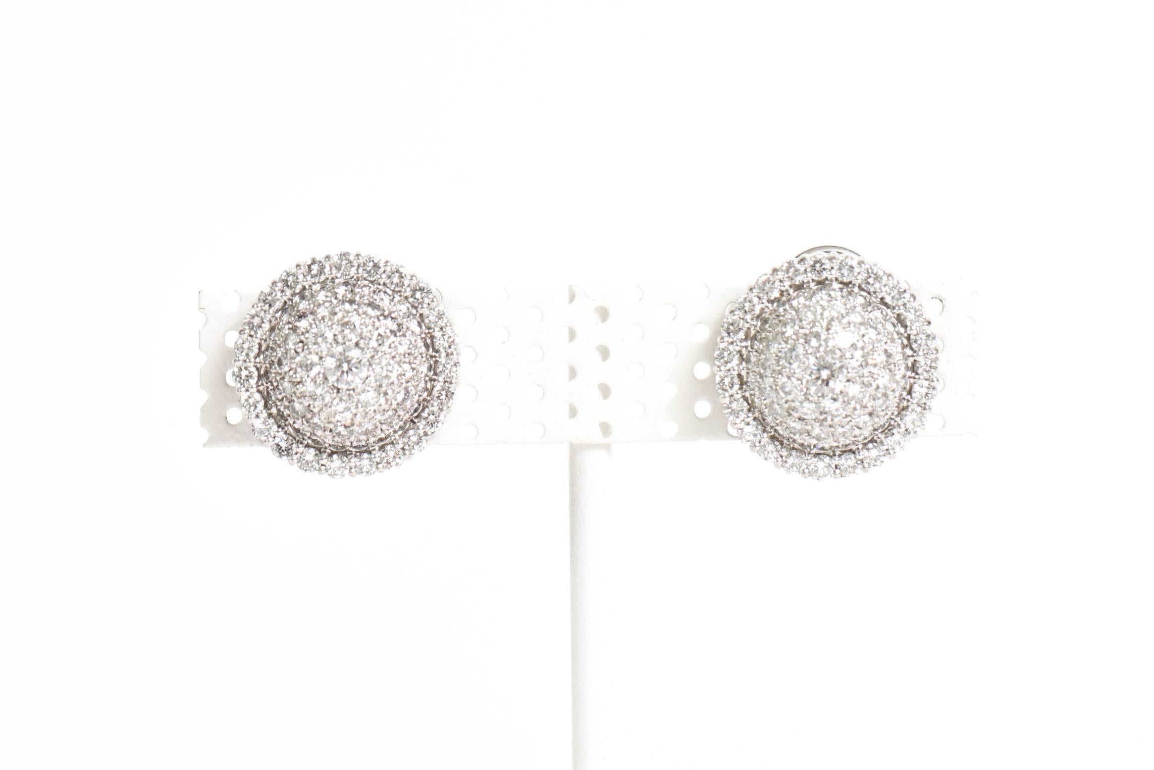 These gorgeous and arresting pair of white pave diamond dome lever back pierced earrings have quite the presence. They are 18K white gold set with all the white diamonds. These stately pair of diamond earrings are classic, timeless and forever. The