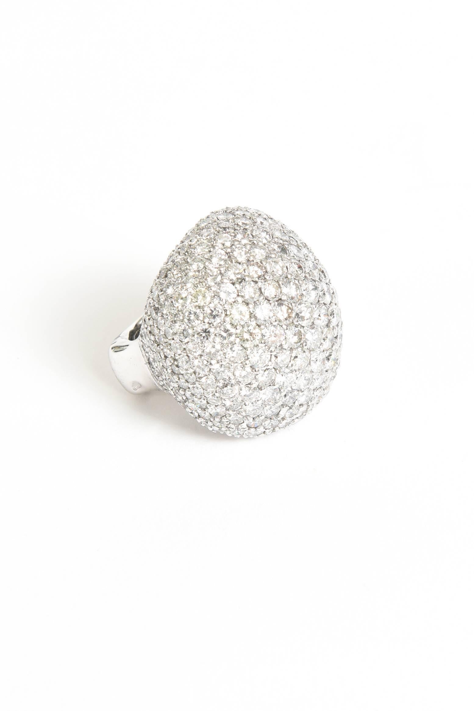 This dramatic and exquisite large cocktail/dome ring is not for the timid. It has high drama to it in an exquisite way.  It speaks volume of diamonds and volume of sparkling light. It contains 24 carats of round brilliant diamonds set in 18 K white