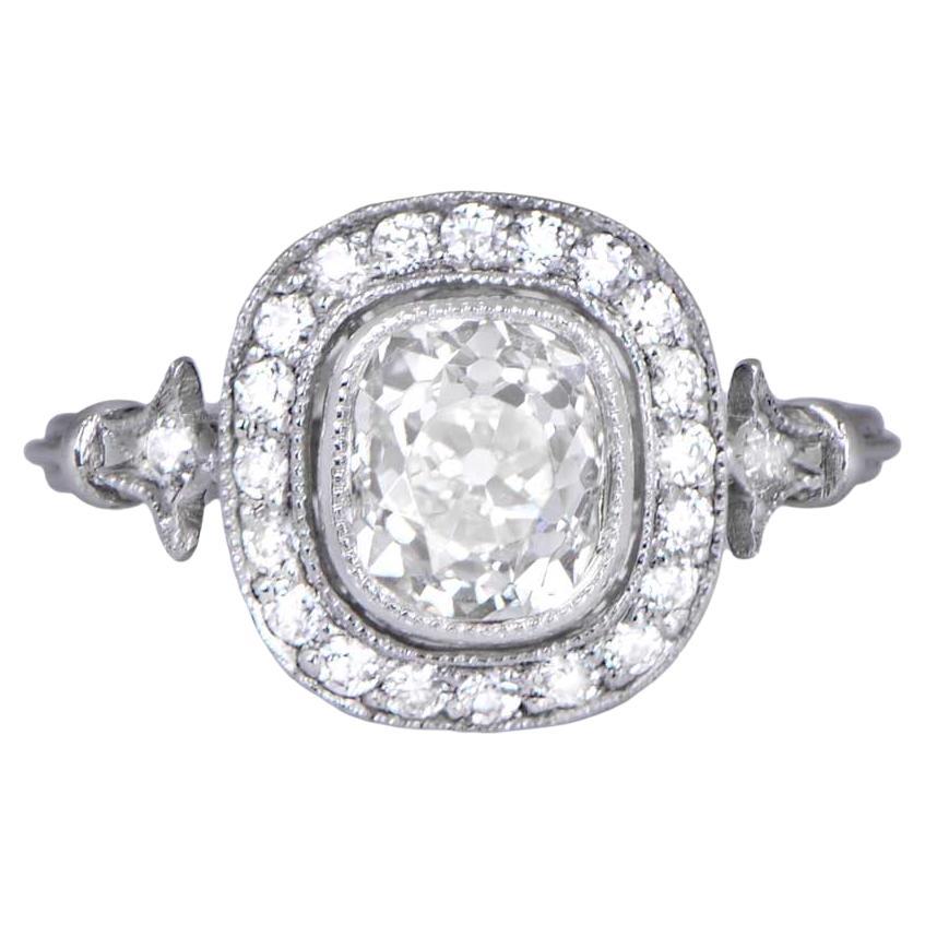 A stunning 1.33ct antique old mine cushion cut vintage engagement ring with a halo of old mine diamonds. Meticulously handcrafted in platinum, it features a delicate triple-wire band and fine filigree on the lower gallery. The center old mine cut
