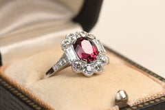 GIA 1.75 Carat Oval Cut Heated Tanzanian Ruby Ring. Diamond Halo Platinum Ring