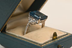 5 Carat Emerald Cut Blue Topaz Ring. Round Diamond Accent 18k White Gold Ring