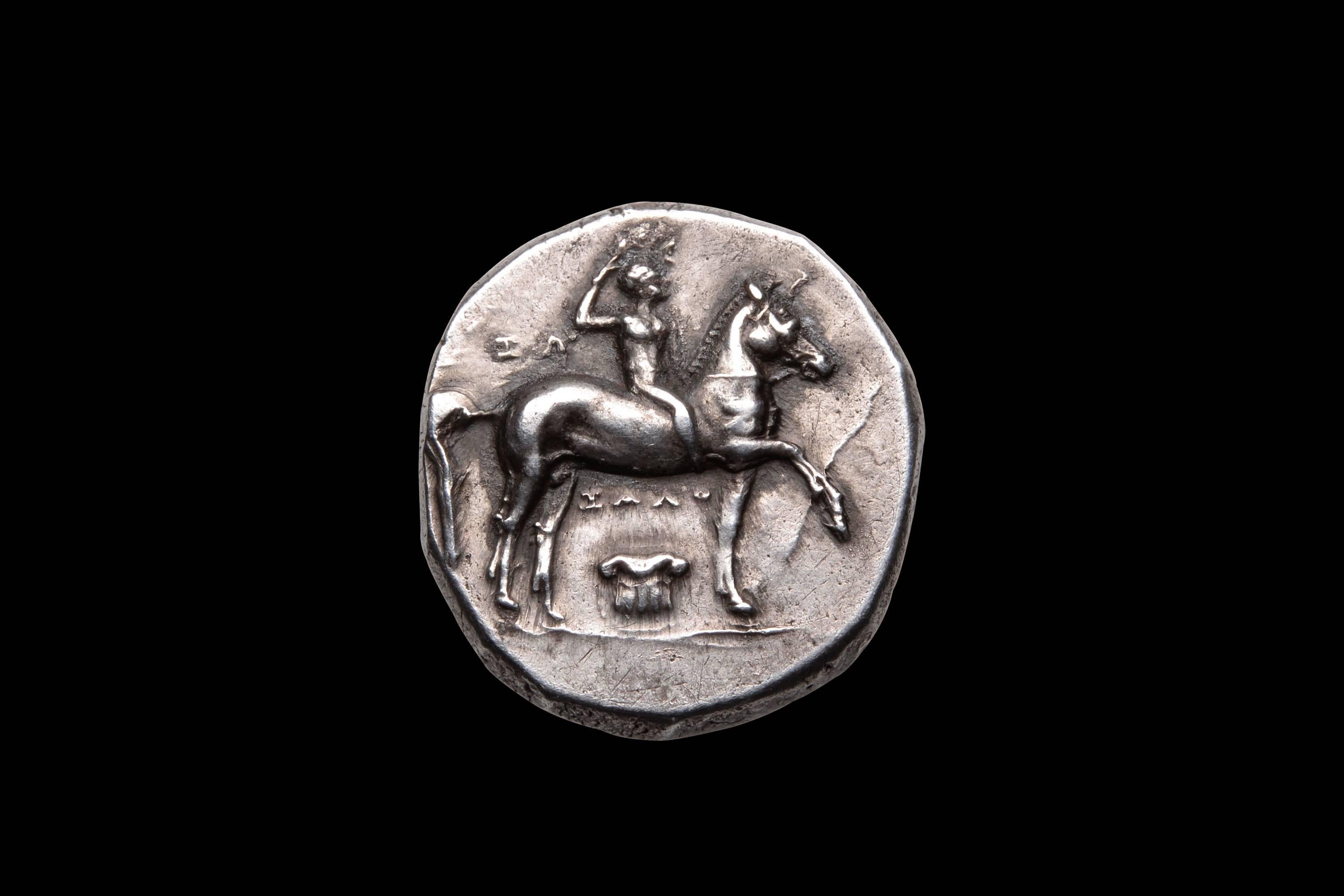 A very beautiful example of one of the most charming ancient Greek coin types. A silver didrachm from the city of Taras, Southern Italy. Struck circa 280 - 272 BC.

The obverse with a naked youth on horseback, shown crowning himself with a laurel