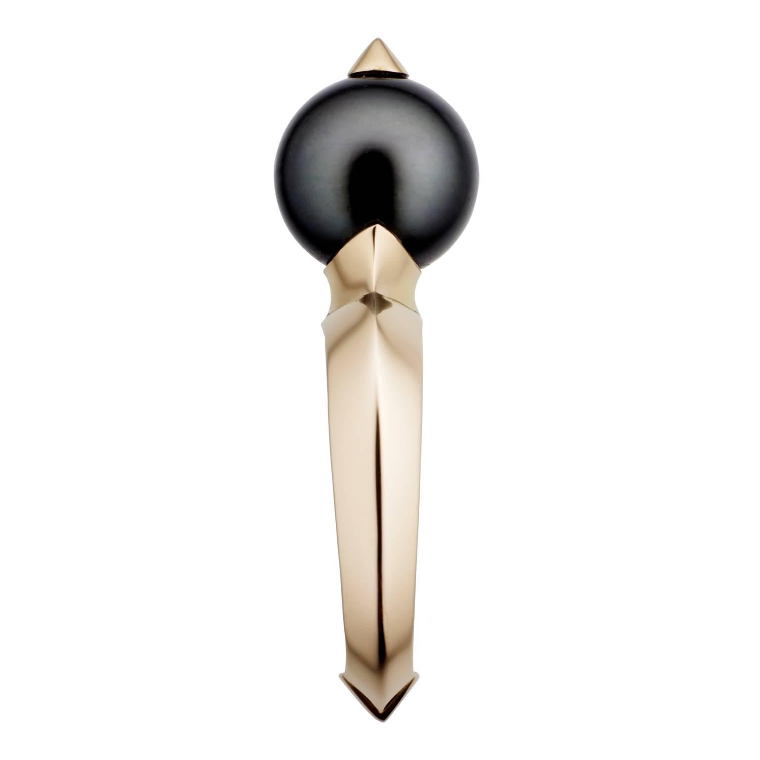 Bold and lustrous, this inky-grey Tahitian Pearl has been stabbed by 18 carat rose gold, and now sits in tribute to its stylish wearer on a ring, that challenges convention without compromising elegance. 

The signature Hannah Martin knife-edge