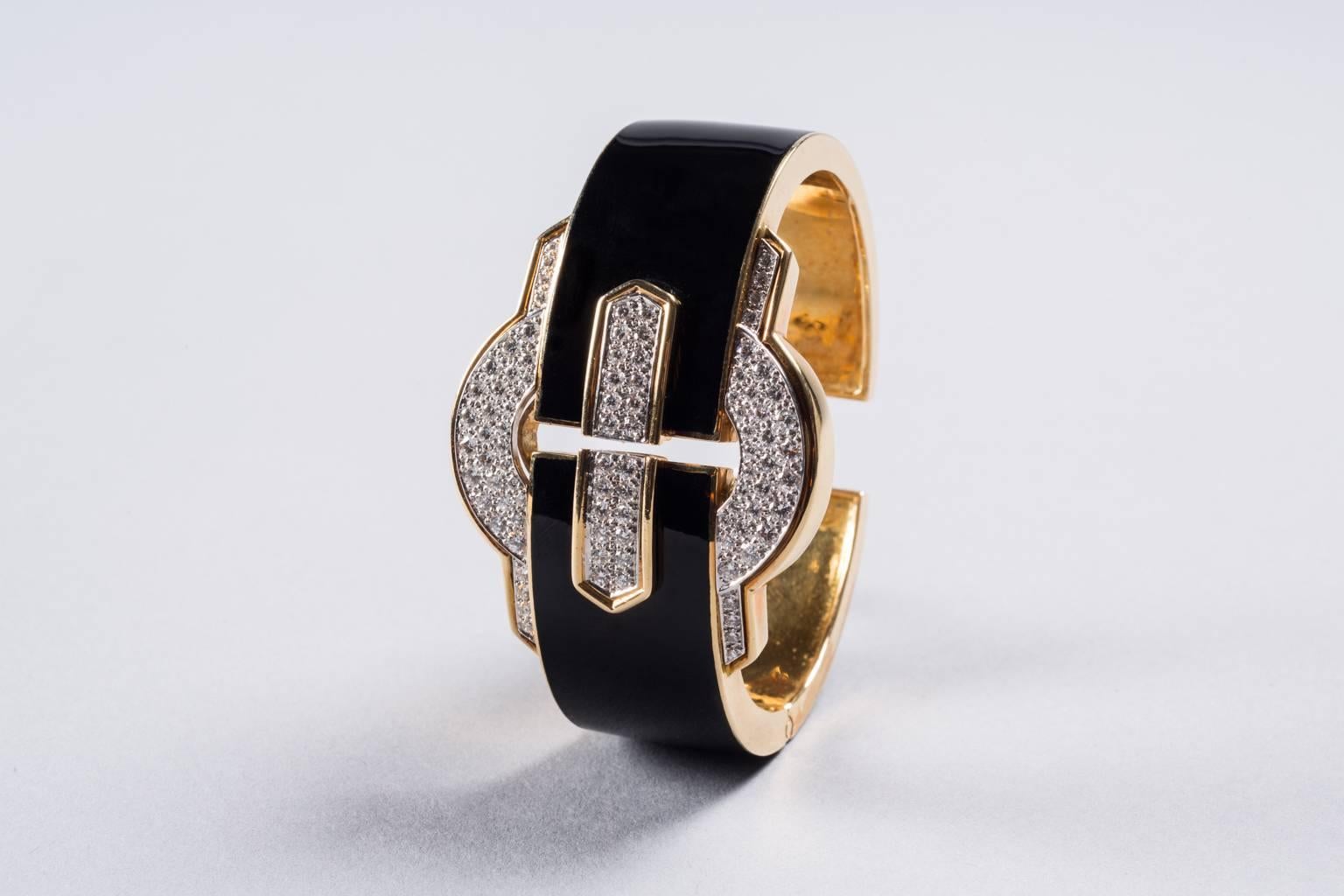 David Webb diamond, 18k gold, platinum and enamel bracelet with hinged cuff.

USA, ca. 1970s
Stamped {David Webb}

Weight: 2.45 carats [F-G, VS2] 95.1 grams

Measures: 2.2 x 1.6 inches inside diameter.

