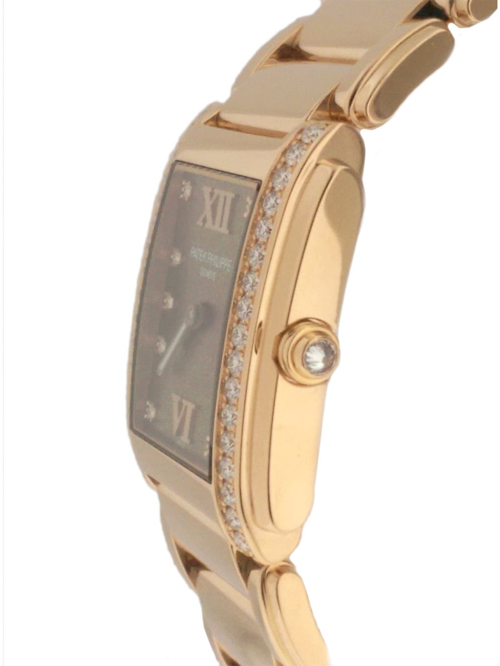 Ladies Patek Philippe Twenty 4 in 18K rose gold, Ref#4910/11R. On 18K rose gold bracelet with concealed clasp, diamonds set on sides of case, diamond crown, case dimensions 30mm x 25mm. Quartz movement. Chocolate dial with diamond hour markers and
