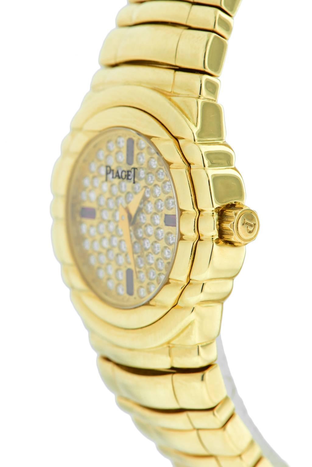 Ladies Piaget Tanagra, in 18K Yellow Gold With factory Diamond pave dial and Stup cut ruby hour markers. On 18K Yellow Gold Bracelet with double folding hidden clasp. 25 mm case. Quartz movement. watch fits up to 6 1/2