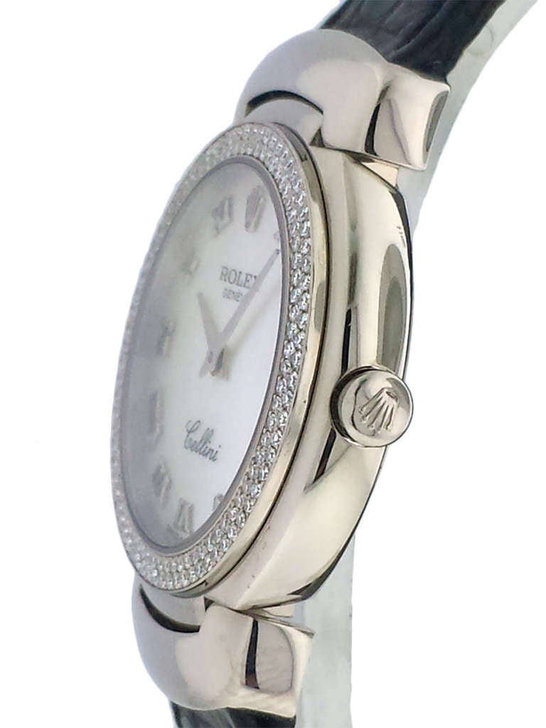 Rolex lady's 18k white gold Cellini wristwatch, Ref. 6671, with double-row diamond bezel, on strap. 26mm case, quartz movement, mother of pearl dial with applied Roman numerals. With box.