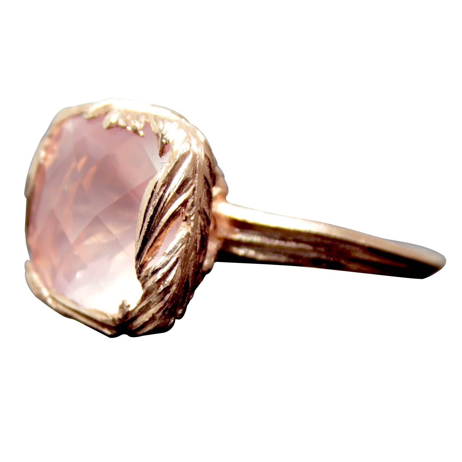 Rose Quartz Cushion Cut stone set with a wrap of hand carved feathers, mounted to a grooved tapered ring shank. William Cheshire wanted to create a large but delicately made ring with an organic feel. The gentle feathers create the setting as they