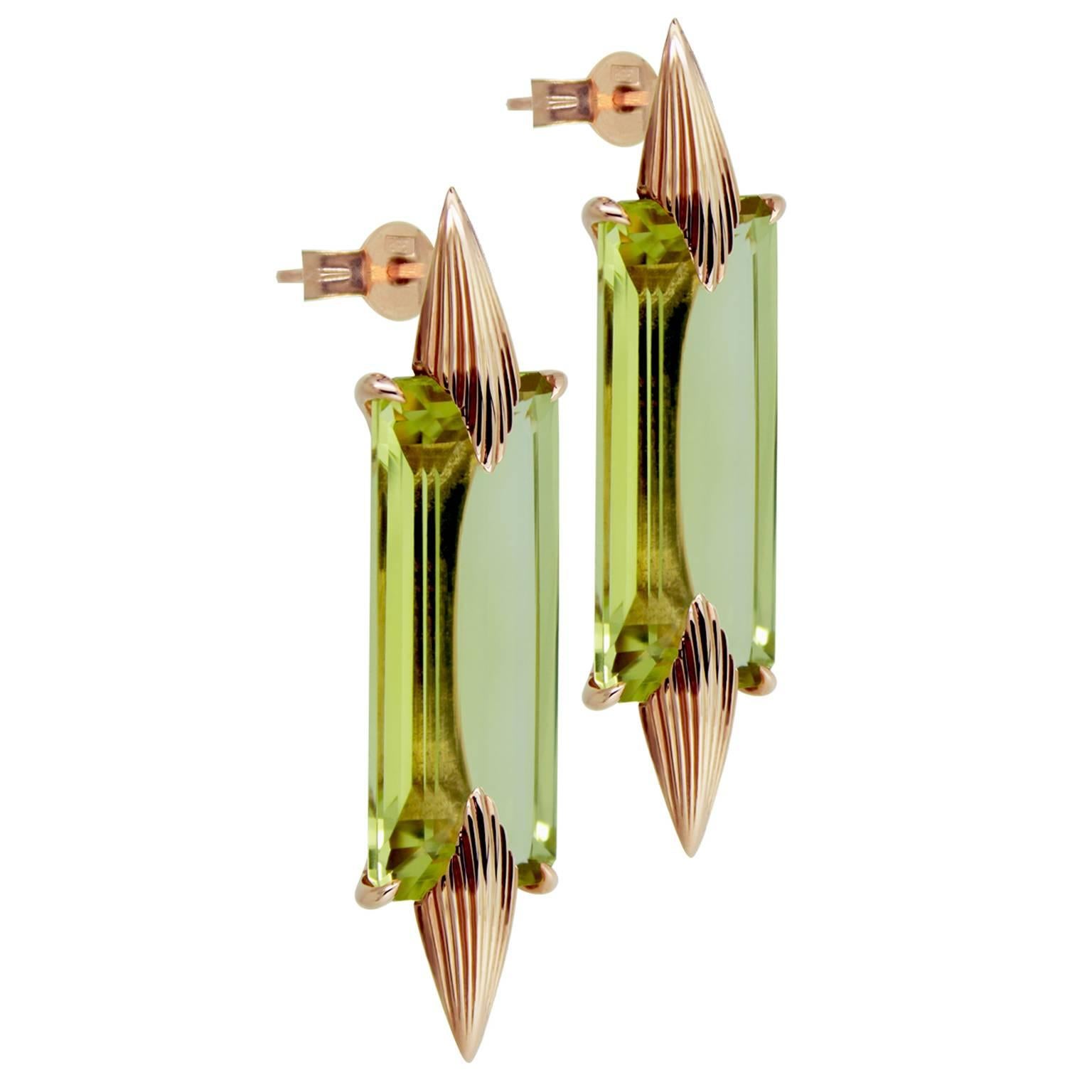 A striking pair of Brazilian Lemon Quartz earrings. Set in 9k Rose Gold four claw mount with elegant detailed tapered spikes. The stones measure 25mm height x 10mm width x 7mm deep total 27ct. The baguettes are held from the back with a simple
