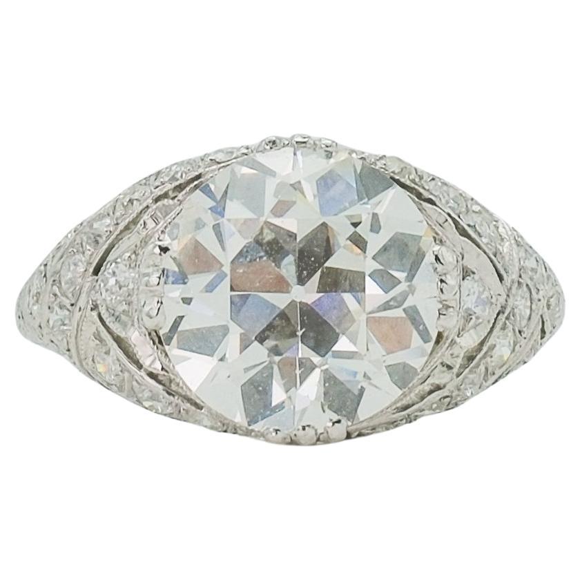 A lovely antique Art Deco platinum solitaire ring centered with an Old European cut diamond weighing 4.14 carats. The diamond has been certified by the Gemological Institute of America and graded as a J color with SI2 clarity. Despite the grading