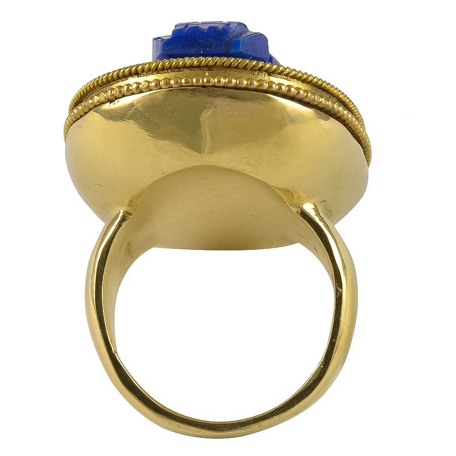 The fine colour geometric Lapis Lazuli Scarab is set in a heavy Gold Canatille work mount, testing for 18k Gold.

A very imposing Ring and in good condition.

Dimensions:       1 3/16 L x 14/16 W
Size:   USA   5 1/2                         UK 