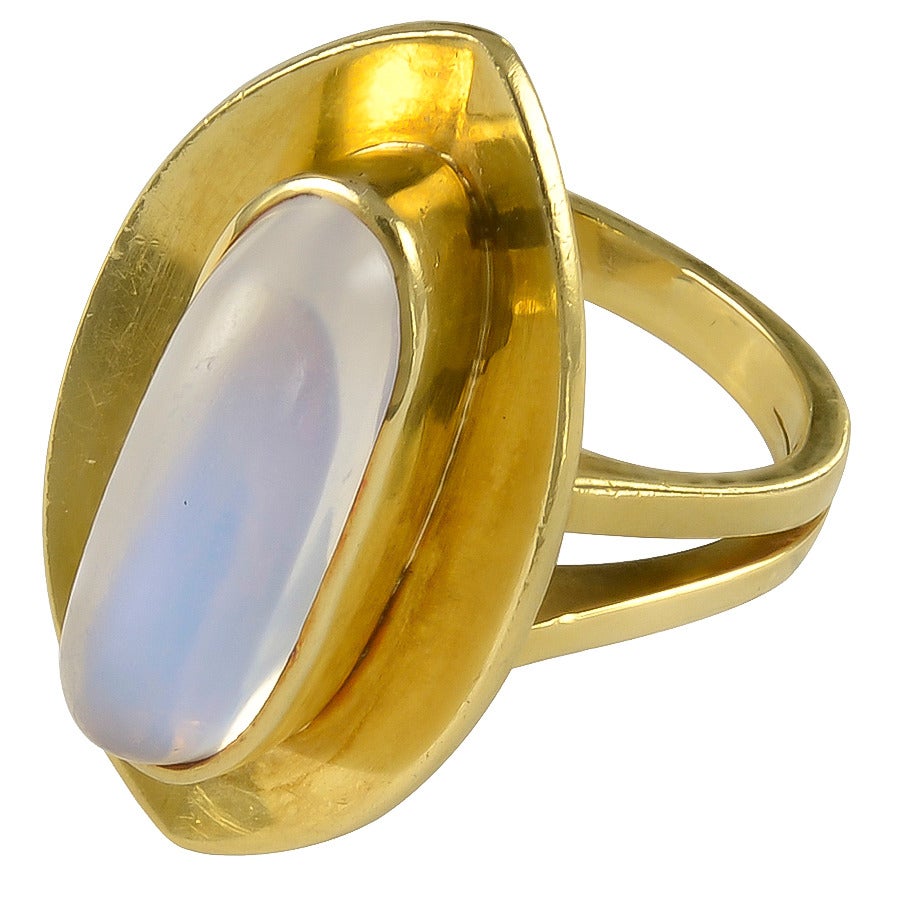 The slightly concave Gold Bezel is set with a long oval Moonstone of good colour. The twin shouldered shank stamped 750 for 18k Gold.
Dimensions: 1 inch long x 10/16 inch wide
Size:  USA  5 1/4          UK  K           CN  10          Condition: