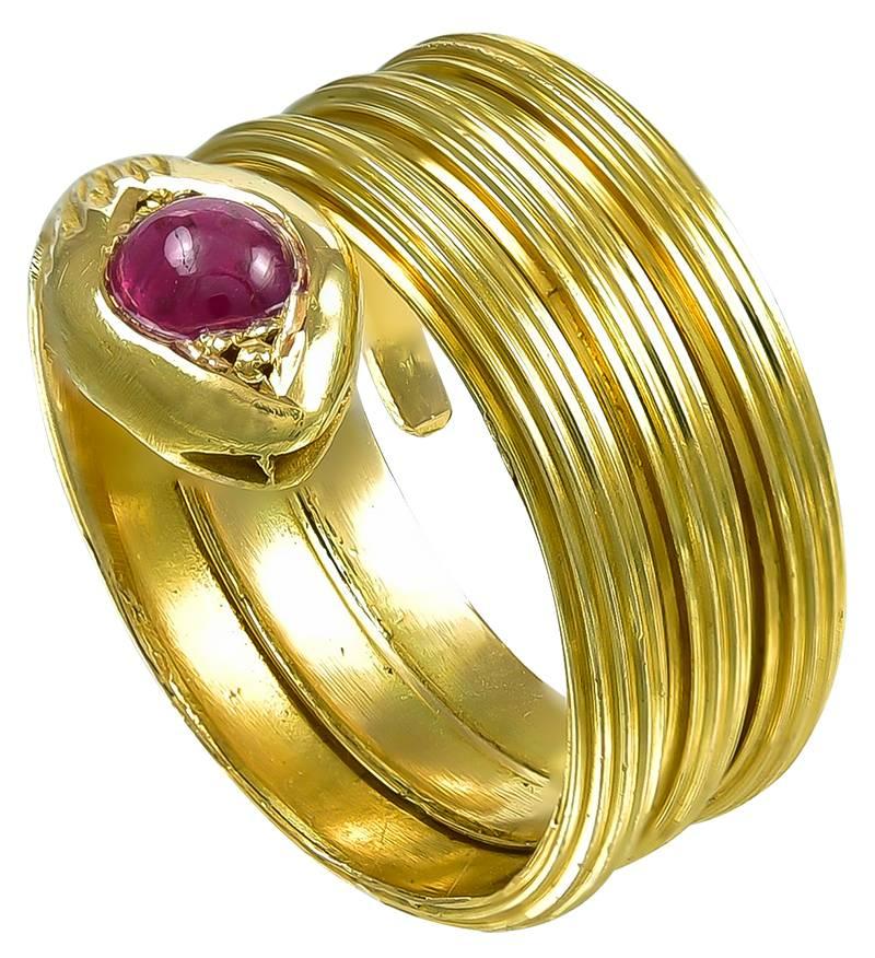 The reeded Gold 4 coil serpent is set with a Cabochon Ruby in its head and inside the coil is stamped Greece and behind the Snake's head are further marks: the Lalaounis registered mark, A21, and 750 for 18k Gold.
Because the Ring is constructed