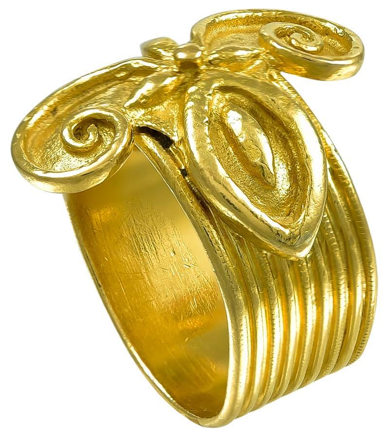 Modelled on an ancient Greek original, the applied Gold Butterfly flies across the finger and is mounted on a multi reeded Gold shank which is not soldered shut so that the Ring can be adjusted to fit any finger.
At the end of the shank are the