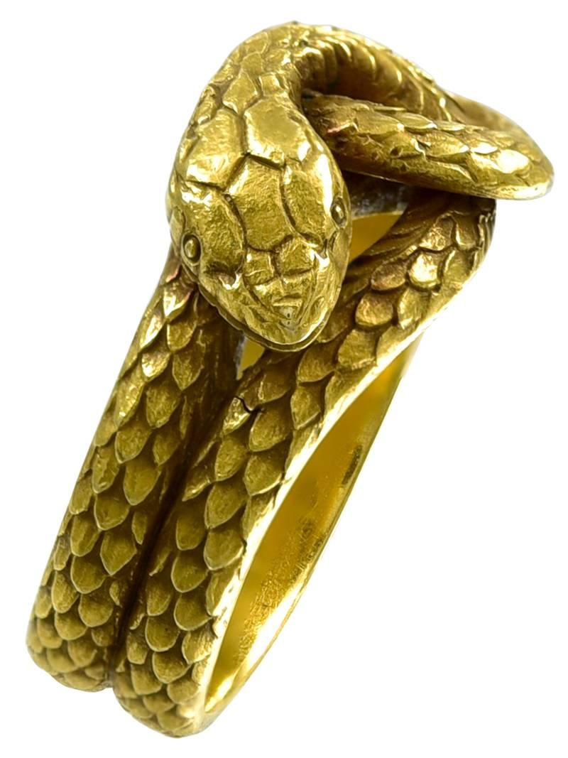 The fluidly moving Serpent beautifully engraved with scales throughout its exposed body. A first class example of the best in American Snake Ring Jewellery making. The inner shank stamped 14k, but no makers mark. 
Condition: Good
American circa