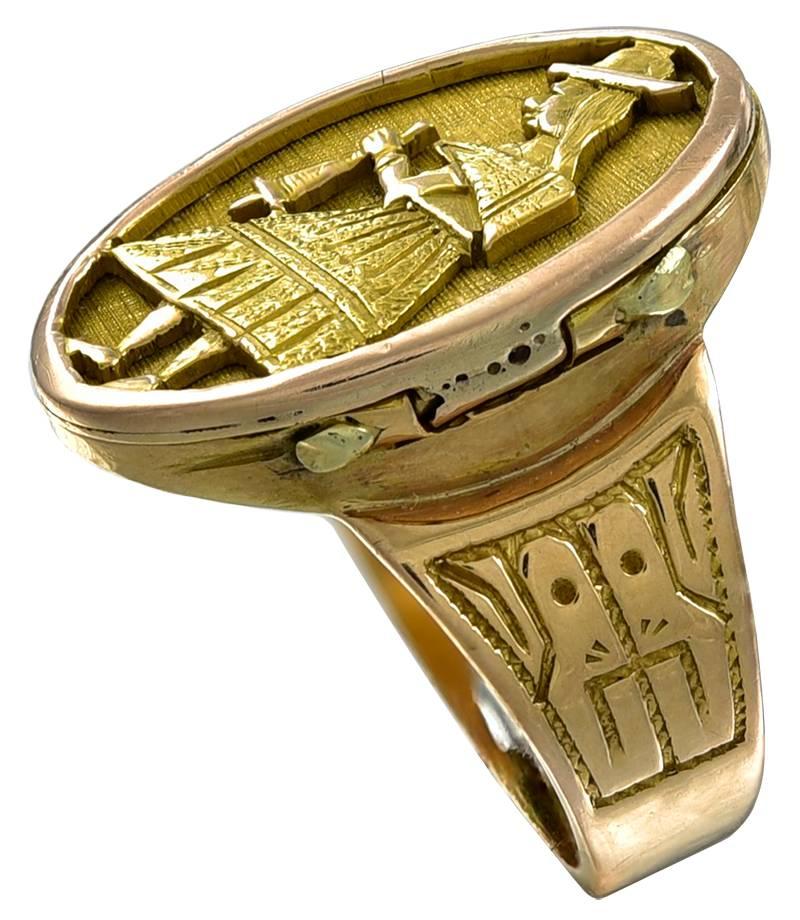 The hinged oval top is decorated with a hand cut relief of a woman in Andean costume holding a tool? and the the shoulders are engraved with pre Columbian Mayan masks. This is an interesting Ring that I recently found in the UK.
The Gold is unmarked