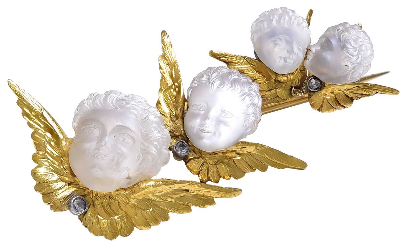 The melting charm of this piece cannot be measured in ordinary jewellery terms.
4 little winged boys, Cupids, Putti, Amorini or whatever term you wish to use, cascade down from a small pair of whispering heads to to the largest smiling head, all