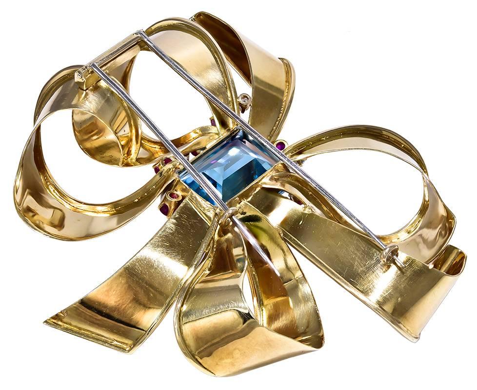 With a large rectangular Blue Topaz, a surround of 17 Rubies and 3 Diamonds and huge curling Gold Ribbons, this is a blockbuster of a Brooch that will startle the most seasoned jewellery blogger into a reflective silence.
Two strong double pins on