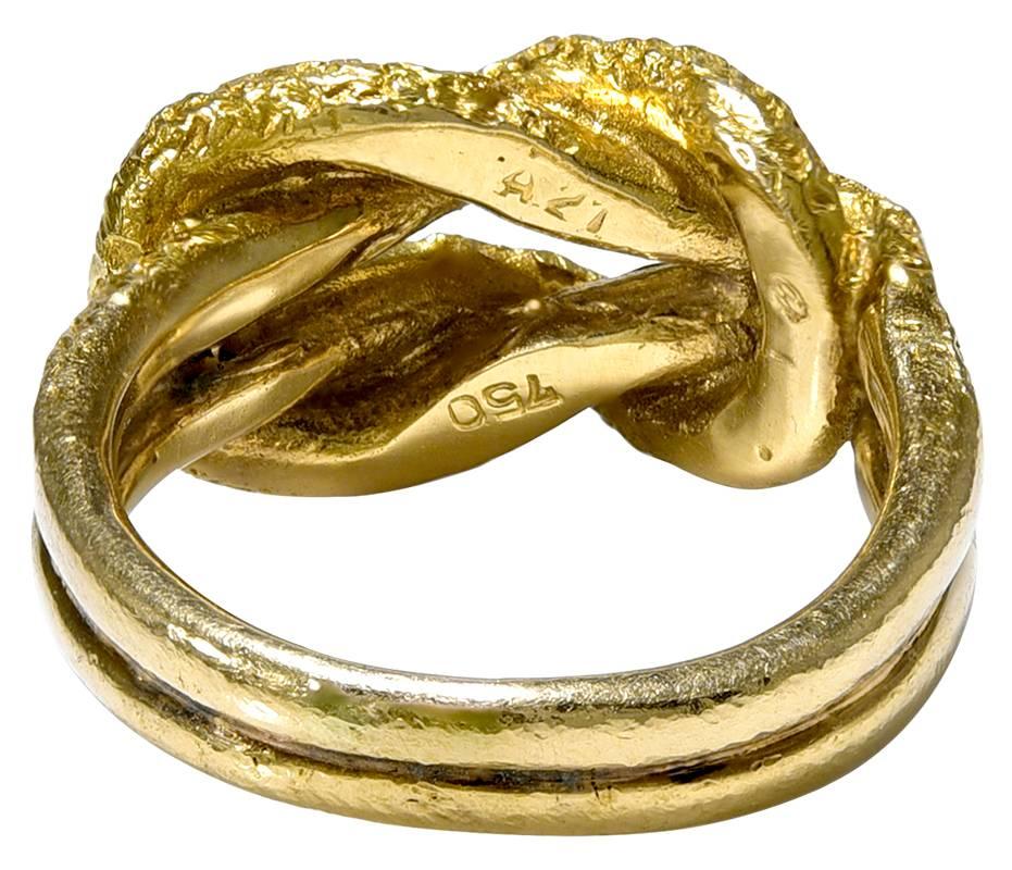 The textured Gold Rope top is known from antiquity as Hercules Knot and the rope continues to form a two row shank. The Ring is stamped behind the head with the Lalaounis registered mark and A21 
a Greek control mark.
and 750 for 18K Gold. A perfect