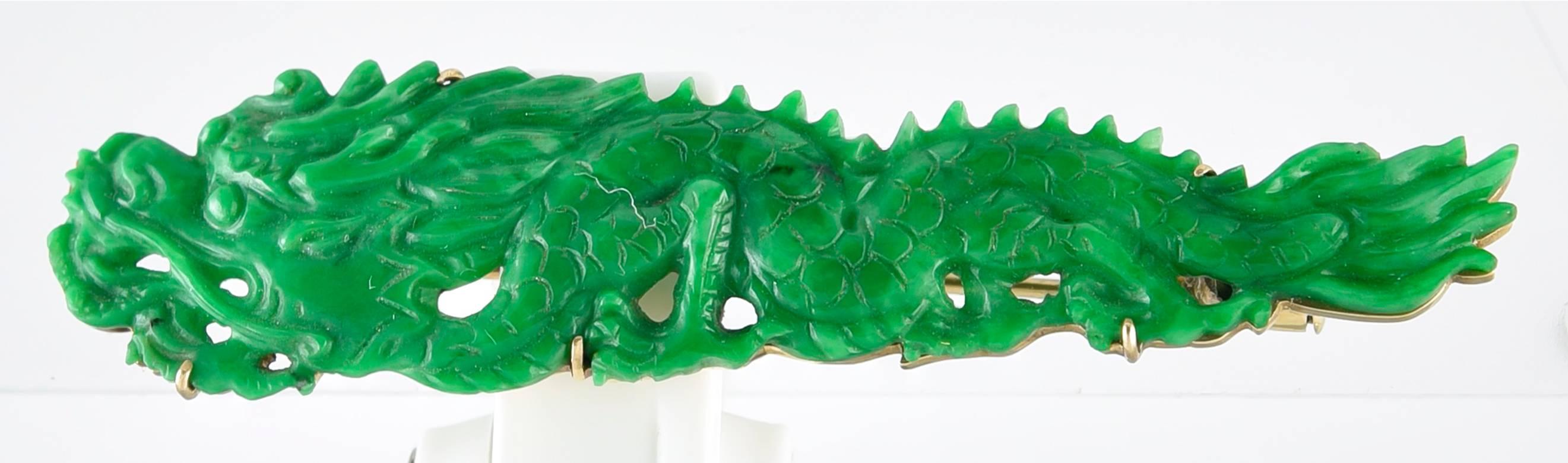 The Jade of rich opaque colour with good detailing which captures the movement of a Chinese stalking Dragon.
Carved, most probably, in Hong Kong in the early part of the 20th century, the carving is mounted on a Gold frame of the period, stamped