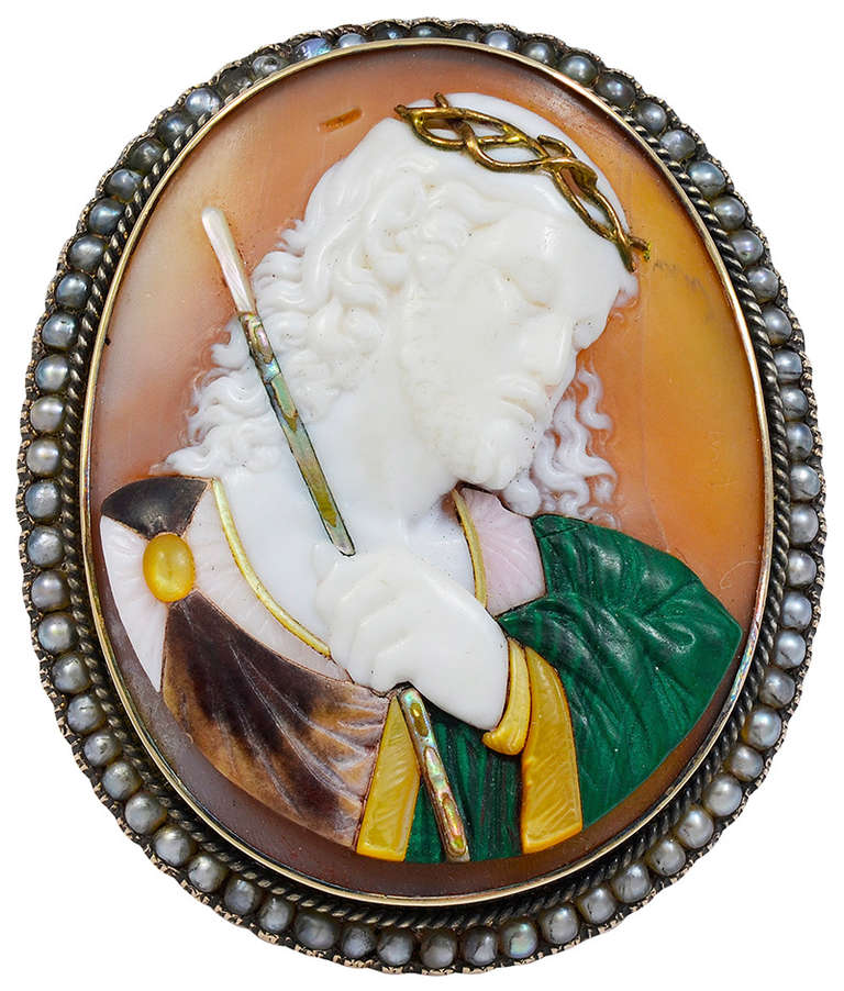 The carved shell Cameo richly inlaid with abalone and other colored shell inserts, mounted in a Gold Brooch frame with a surround of small Pearls.
There is a slight fissure in the shell to the right of Jesus head but it does not reach the surface