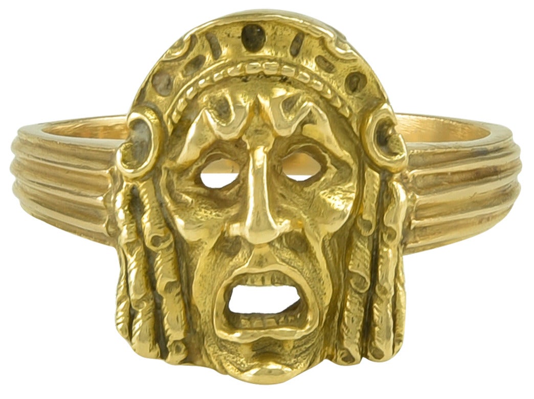 in the form of an Ancient Greek Tragic Theatre Mask, probably skilfully copied from one in the Louvre Collection, even down to the Gold Teeth.
This design has been used in scary movies so has a poor public image, but was used 2500 years ago to show