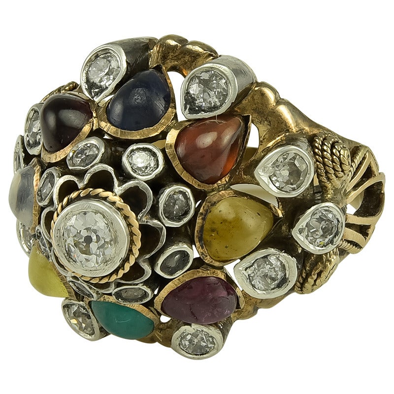 Of imposing size and importance, the Headress inspired Ring design set with a variety of Gems including nineteen Diamonds, Sapphire, Ruby, Moonstone, Garnet etc, eight in all. The inner shank stamped 14k.
Dimensions: 1.5 cm high
Condition:
