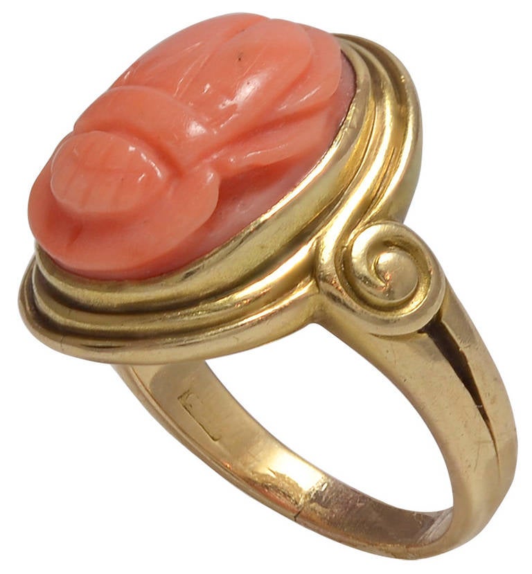 The small carved Scarab in a deep pink colour with two engraved Ankhs in the reverse and set in a Classical Doric style Gold mount. 
Unmarked 14K Gold        Good condition
American circa 1890      Ring size:  USA  4 1/4        UK  i         Japan