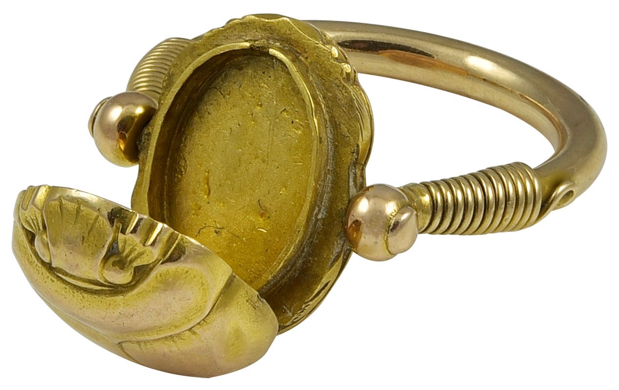 A substantial and well made Ring, the Scarab top lifts to reveal the Locket.
The thick rounded stirrup shaped shank is crafted in the ancient style and the Gold is unmarked and tests for 18k. The Scarab swivels to reveal a Gothic S
engraved on the