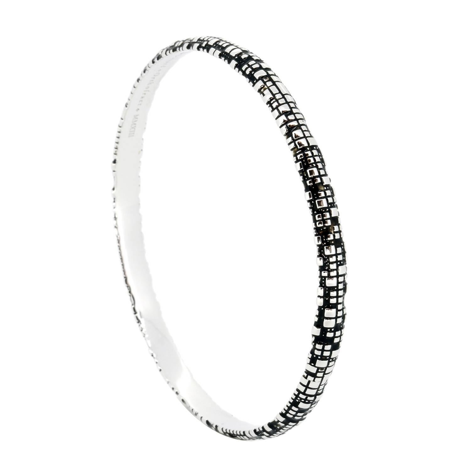 This Blockchain Bitcoin Torus Sterling Silver Bangle Bracelet embodies the intersection of technology and nature. This powerful bracelet features John Brevard’s classic cubic forms. This sterling silver bangle bracelet is perfect for the