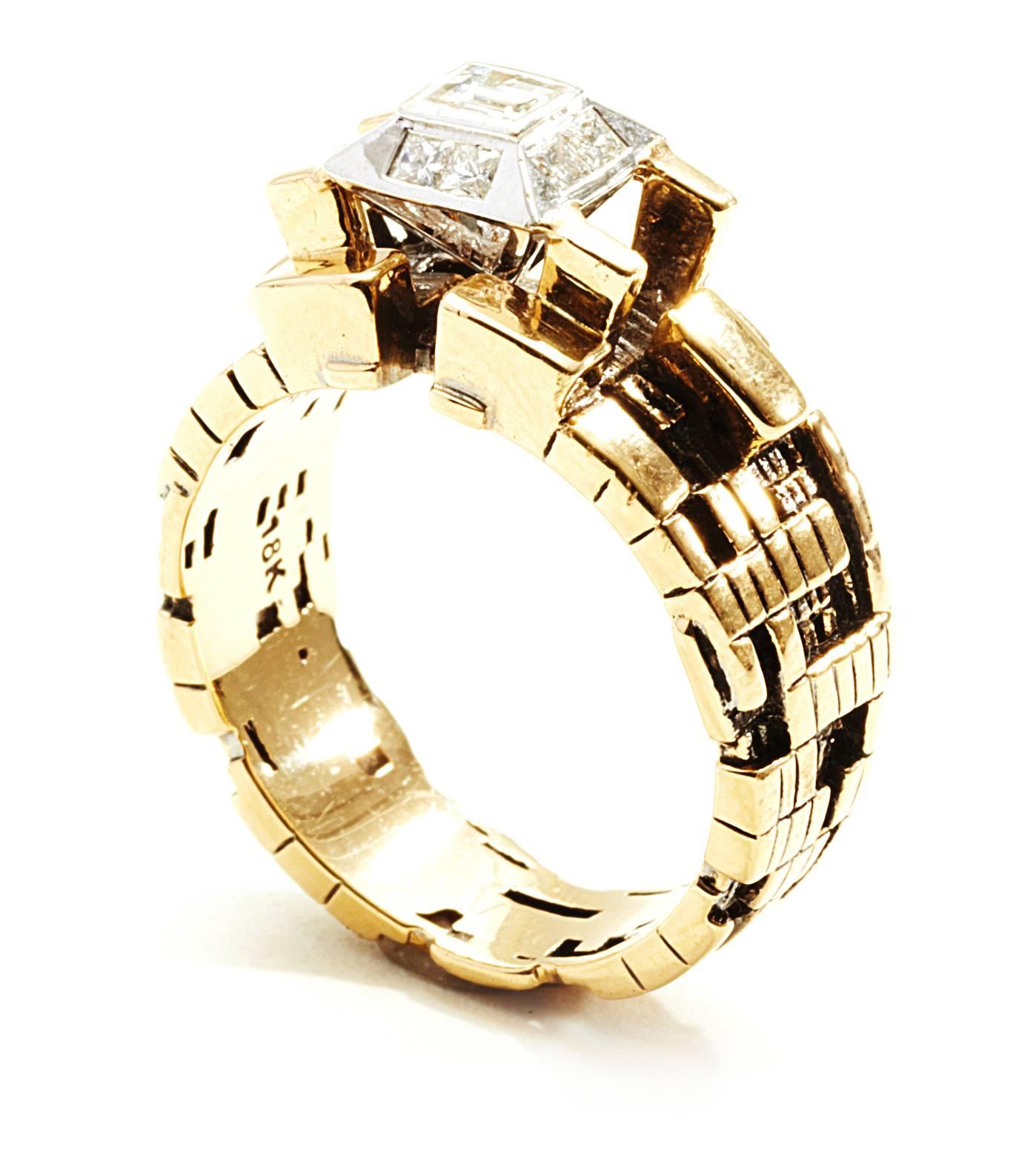 This piece by John Brevard was inspired by the bitcoin blockchain using a parametric modeling tool. Featuring 18K yellow gold with 9 round white diamonds at 2 mm each and 1 center baguette diamond at 3.5 mm, this is the perfect ring for the