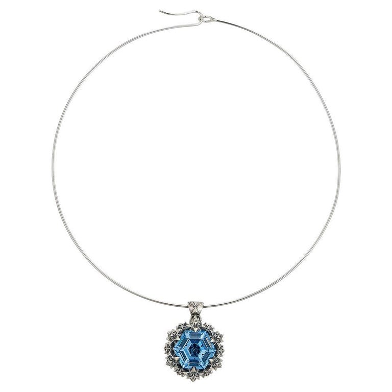 This unique Thoscene Topaz Silver Peace Pendant Necklace features an aquamarine stone set in sterling silver. All of the pieces, including this pendant necklace, in John Brevard’s Thoscene collection are 3D-printed using cutting edge technology. The