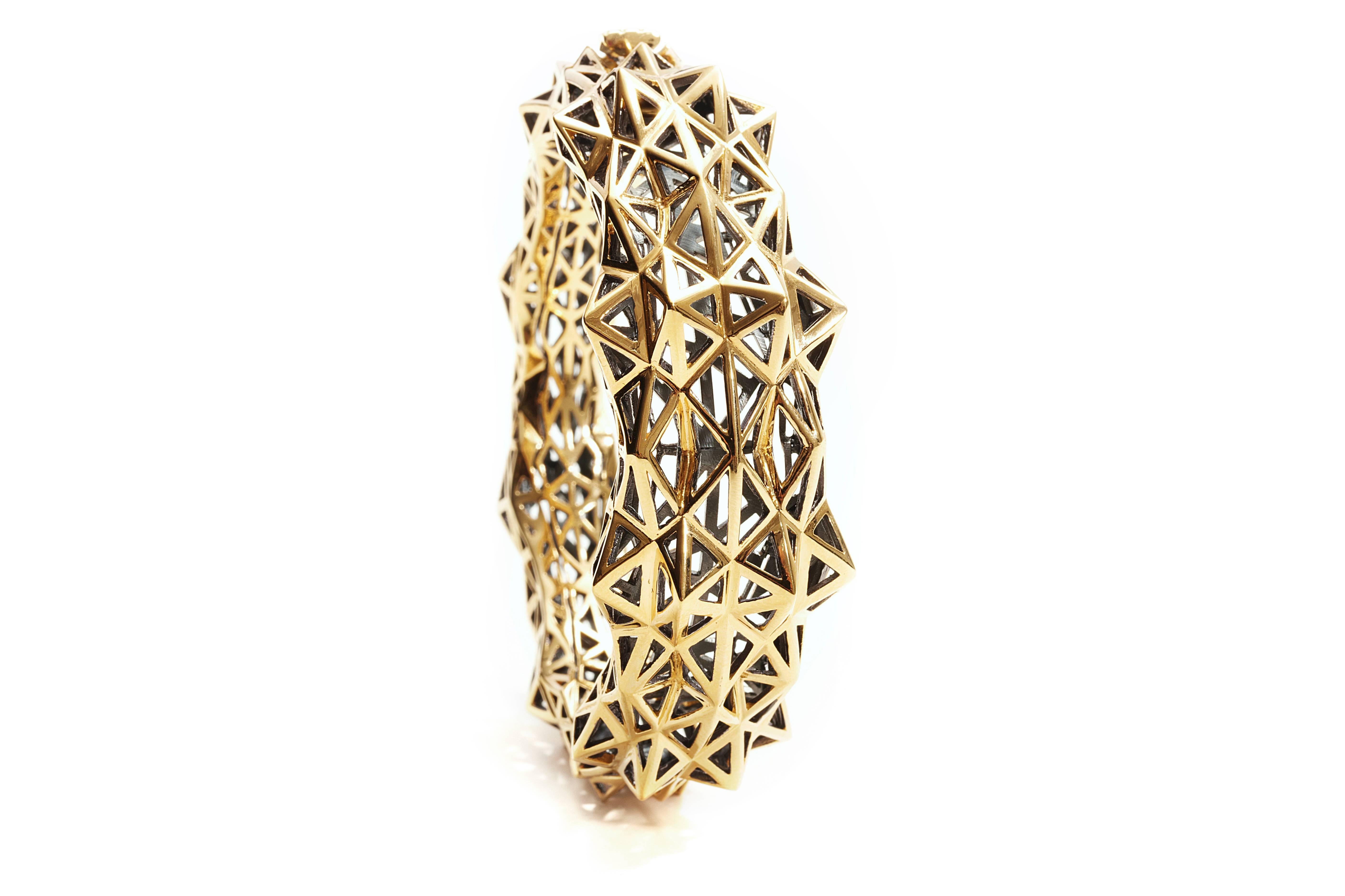 This limited edition, 18K Stellated Gold Bracelet evokes personal power and strength. The geometric patterns of this bracelet fit within designer John Brevard’s larger sacred geometric collections. This unique, hinge bracelet is part of John