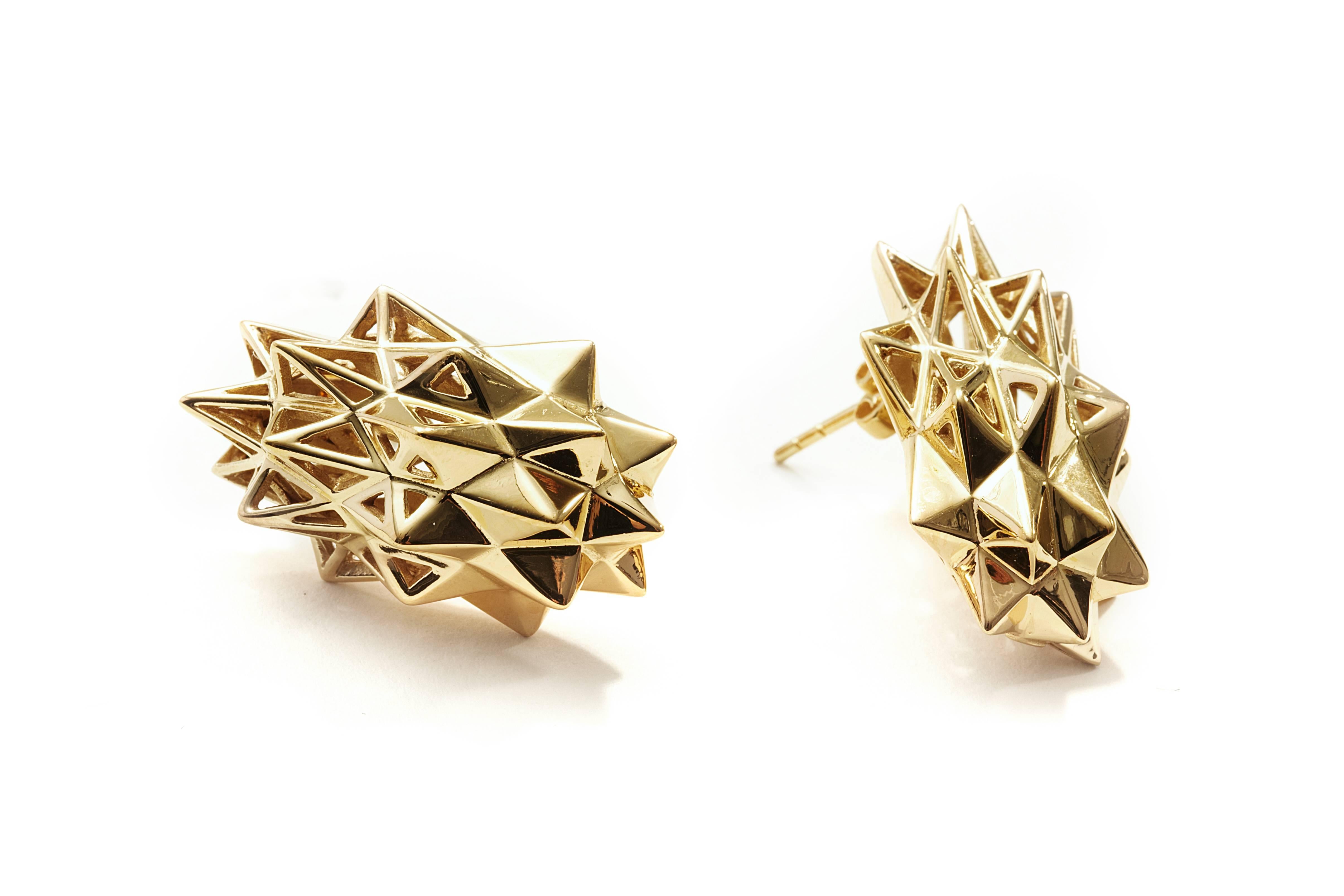 These limited edition, Stellated 18K Gold Stud Earrings are an embodiment of monumental power and strength. These earrings feature sacred geometric forms. This piece's shield-like design mixed with the sacred geometrical form was designed to evoke