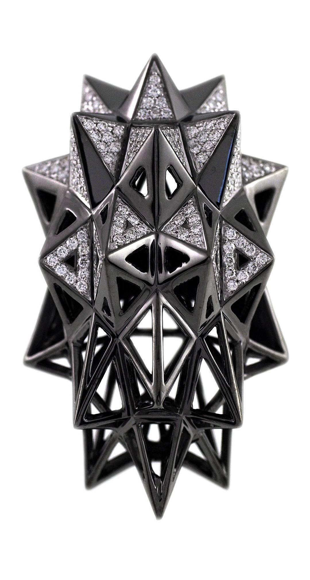 This one-of-a-kind ruthenium-plated, 18K white gold stellated star ring is an embodiment of monumental power and strength. This piece was designed to evoke personal power and protection. This ring is part of designer John Brevard’s Verahedra