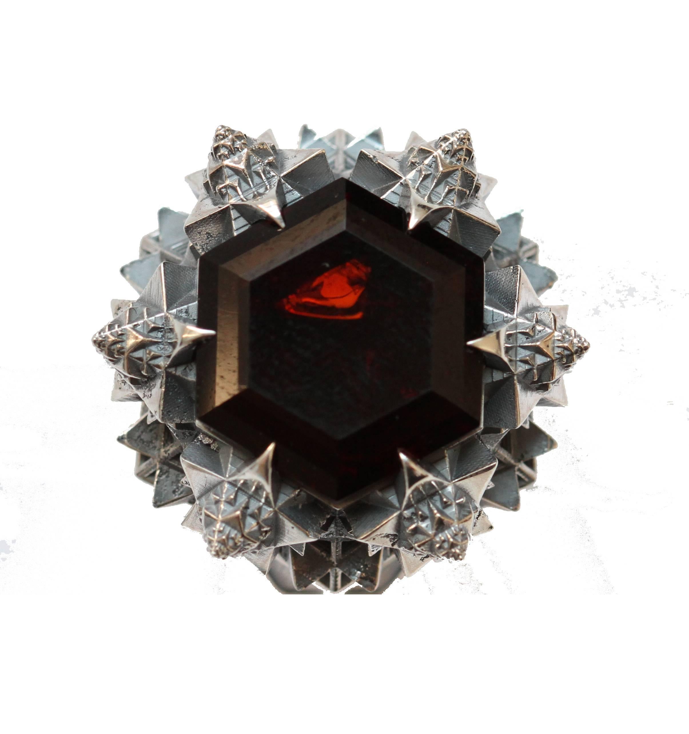 This ring was designed to evoke in ones life. Inspired by the universal birth and created using Thoscene, these pieces evoke a sense of stillness. Thoscene collection ring in sterling silver with a 14 mm Hessonite Garnet. 

John Brevard applies