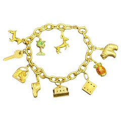 Unoaerre 1970s 18k gold charm bracelet with 10 original stamped charms