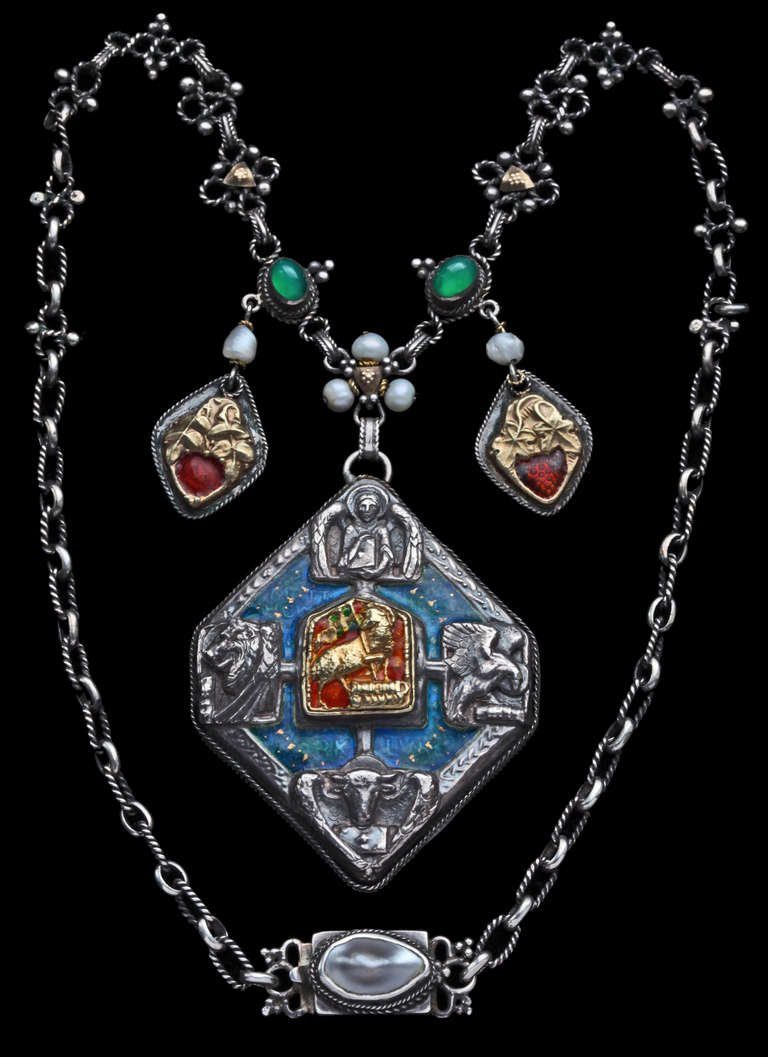 Beautiful documented Arts & Crafts necklace by John Bonnor incorporating the idea of the Holy Trinity (the three Welsh pearls) Eternity (green stones) Agnus Dei & symbols of the four Evangelists. The small pendants the Rose & the Vine
Silver, gold,