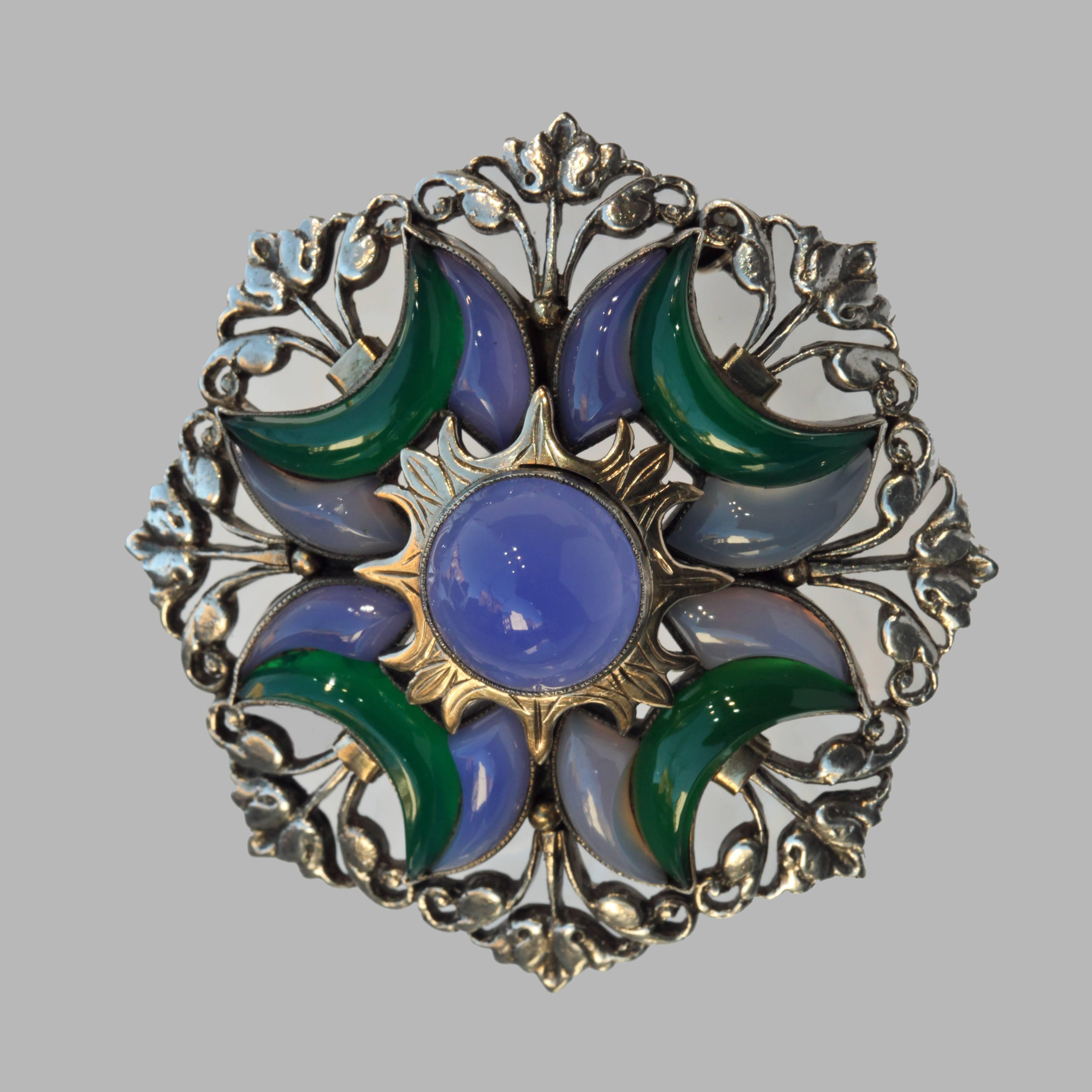 A very fine early Sibyl Dunlop brooch of striking & rare design. The Octagonal form encompasses a Mughal design of an eclipsed sun surrounded by crescent moons of blue & green chalcedonies.