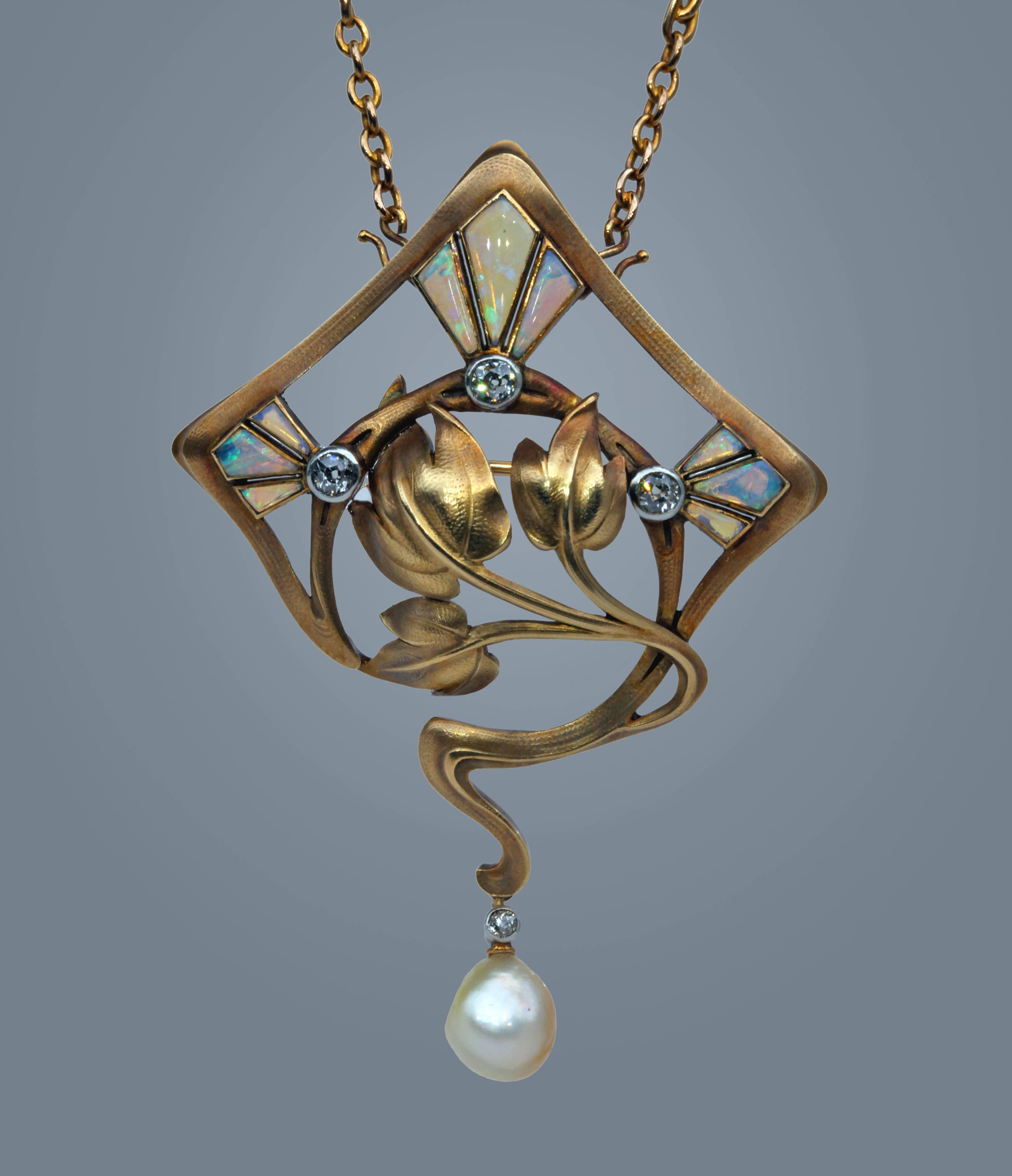 Beautiful pendant in the manner of Georges Fouquet.
Removable chain for wear as a brooch.
There are radical design elements associated with Fouquet, Lalique, Guimard & Colonna featuring opal plique a jour & diamond with comet detail that