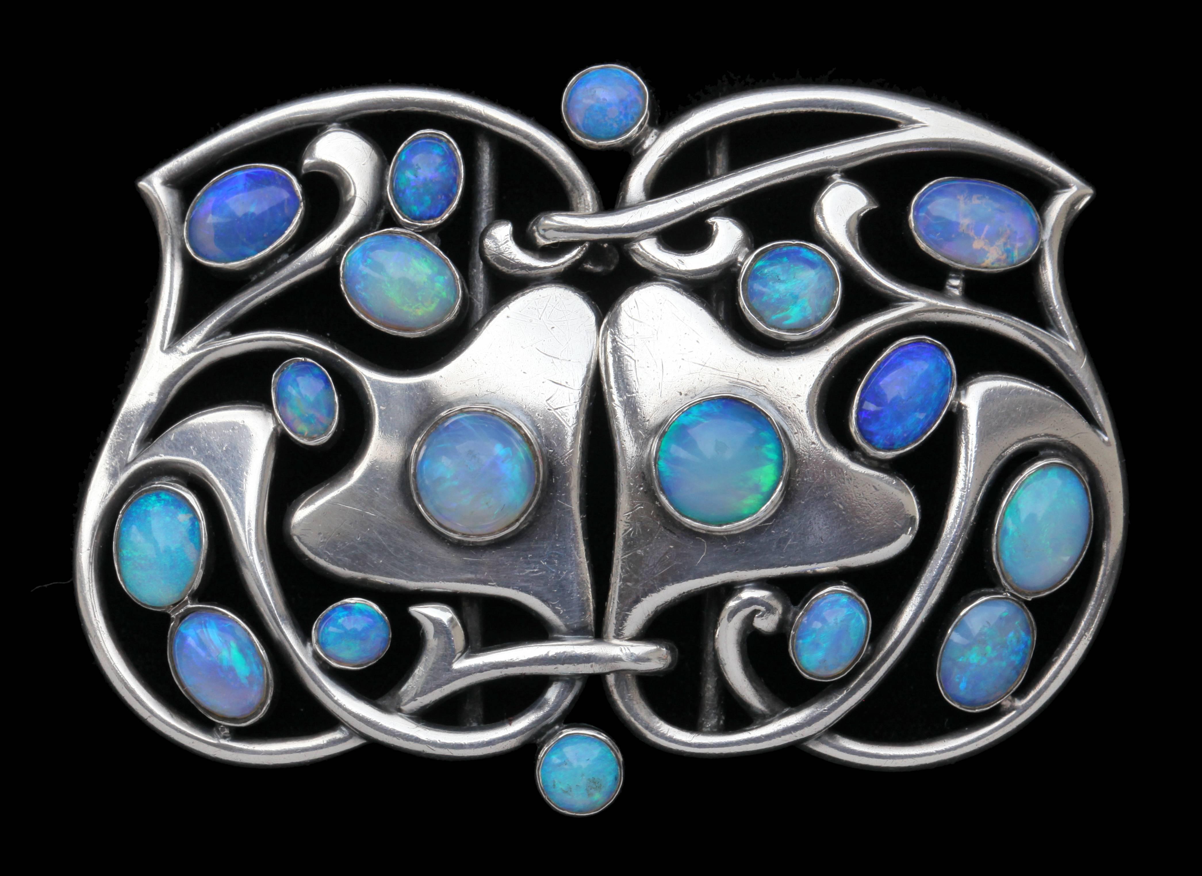 An exceptional Art Nouveau silver buckle by Murrle Bennett & Co set with an abundant selection of beautiful opals.
Marks: 'MBC' monogram & '950'. Fitted case.