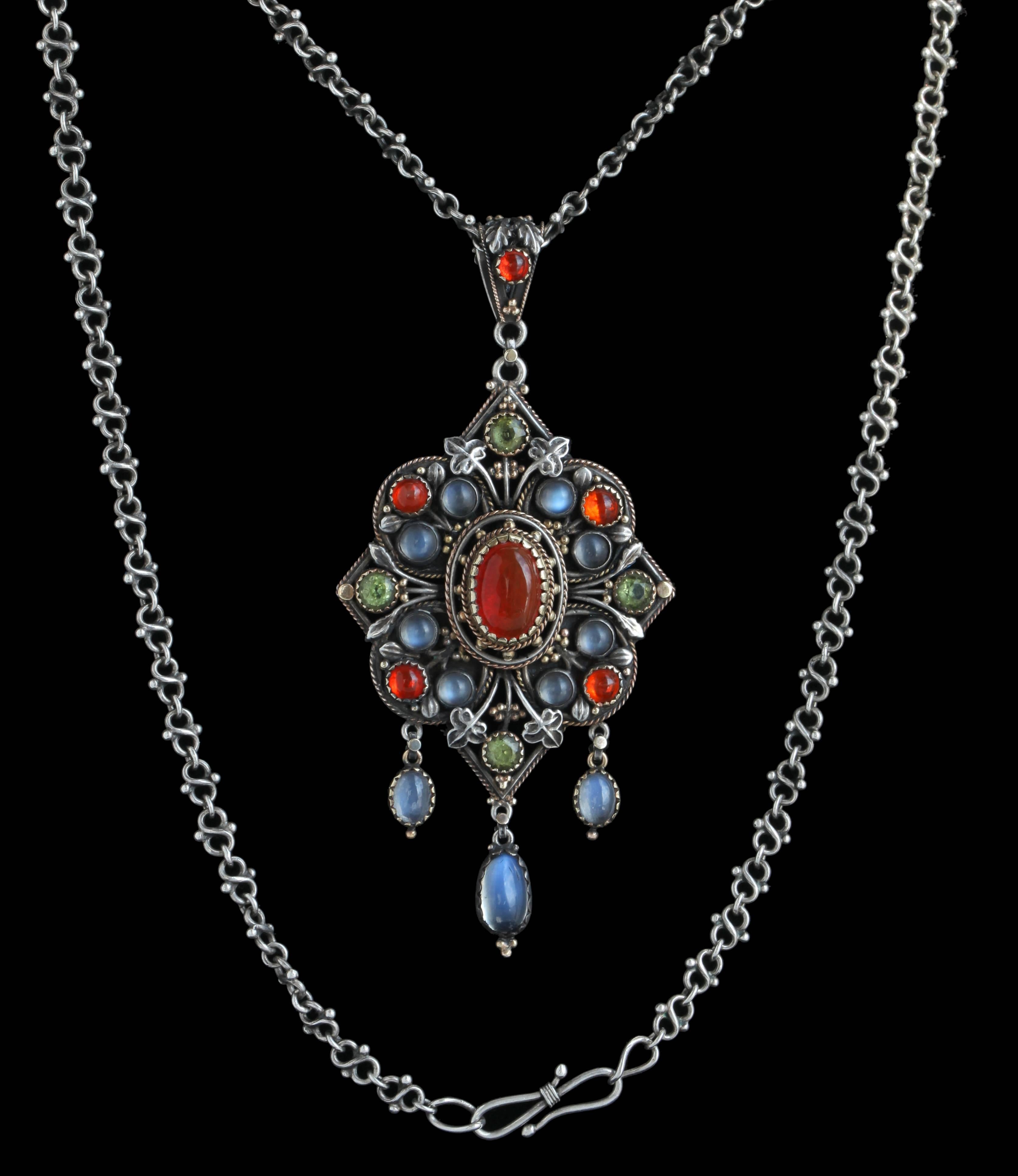 Artificers' Guild. London (1901-1942)
Attributed to Edward Spencer (1873-1938)

Silver, Gold, Fire Opal, Moonstone and Peridot

H  8.10 cm (3.19 in)    W  3.80 cm (1.50 in)    D  47.50 cm (18.70 in)

Origin: United Kingdom, c. 1900
Case: Fitted