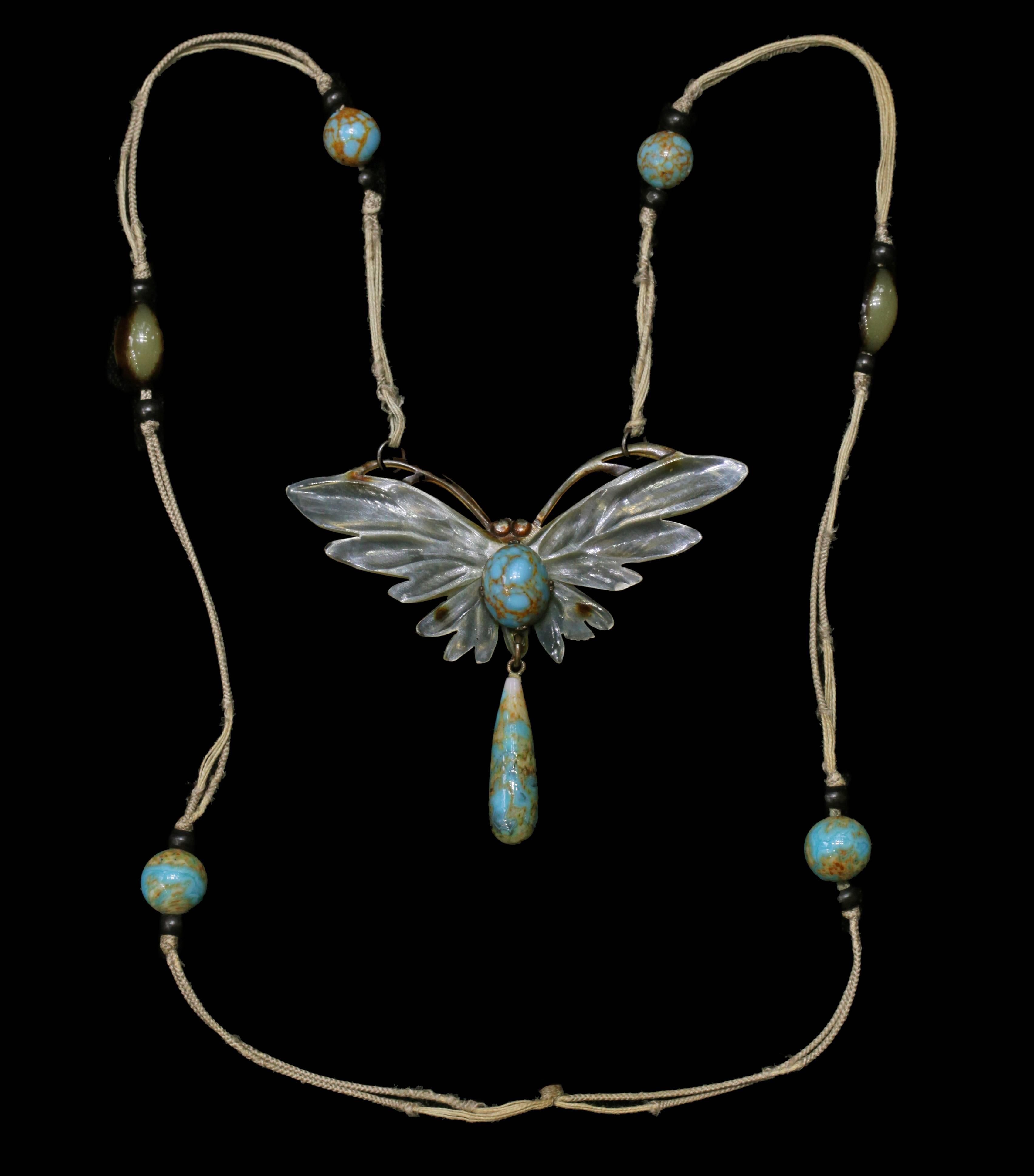 Elizabeth Bonté Art Nouveau Butterfly Pendant. The hand carved horn is heightened with colour. 

Horn, Glass Beads, Silk Cord. Signed Bonté 

Literature:
cf. Bijoux et Reliures-Artistes du XXe Siecle La Bibliotheque des Arts-Paris 1992, pages 30, 31