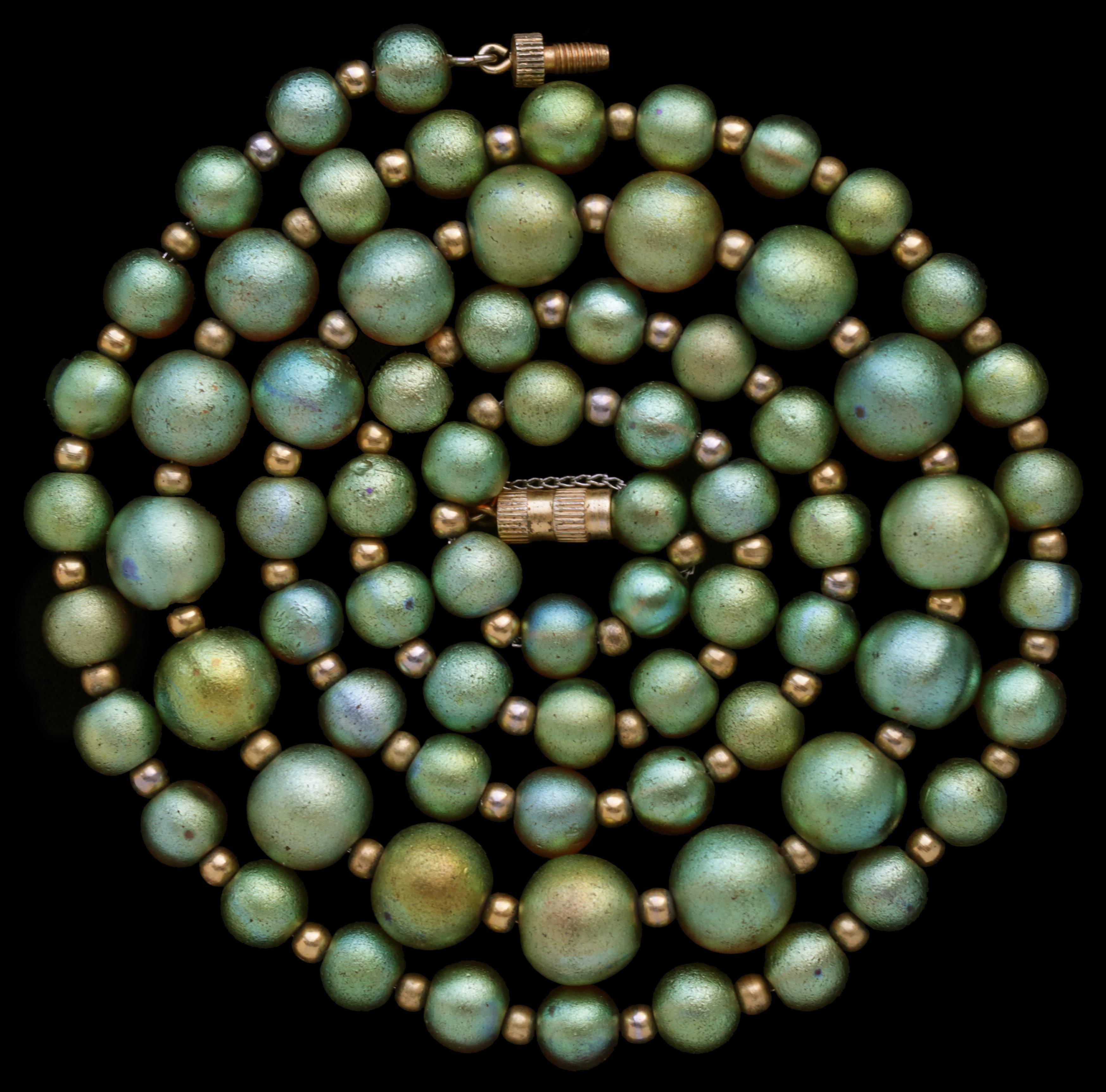 A wonderful & unusually long  string of 73 iridescent green graduated glass beads by WMF Wurttembergische Metallwarenfabrik