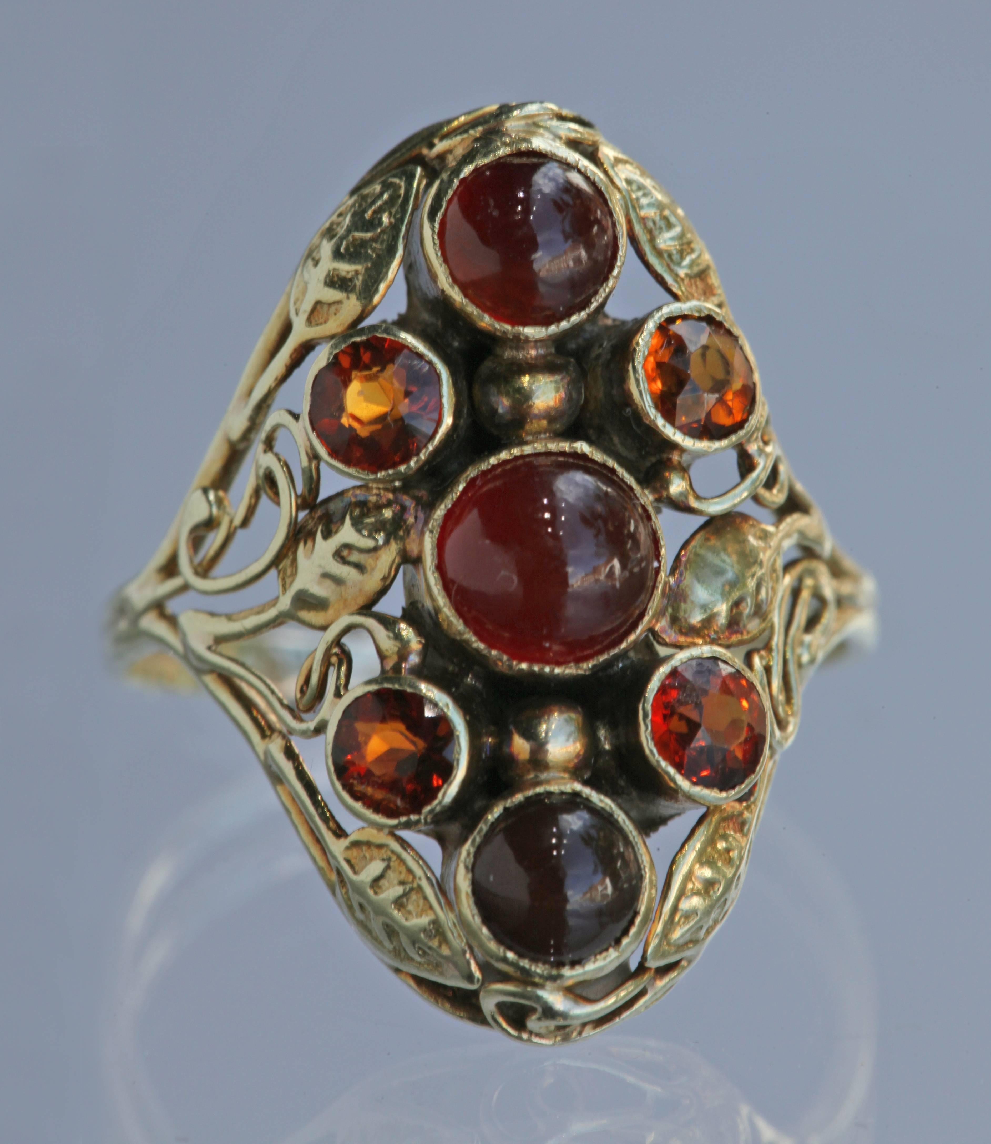 An American Arts & Crafts gold ring with carnelian & citrine. Possibly by Edward Everett Oakes. 
Ring Size: [US: 6.75]  [UK:N ]