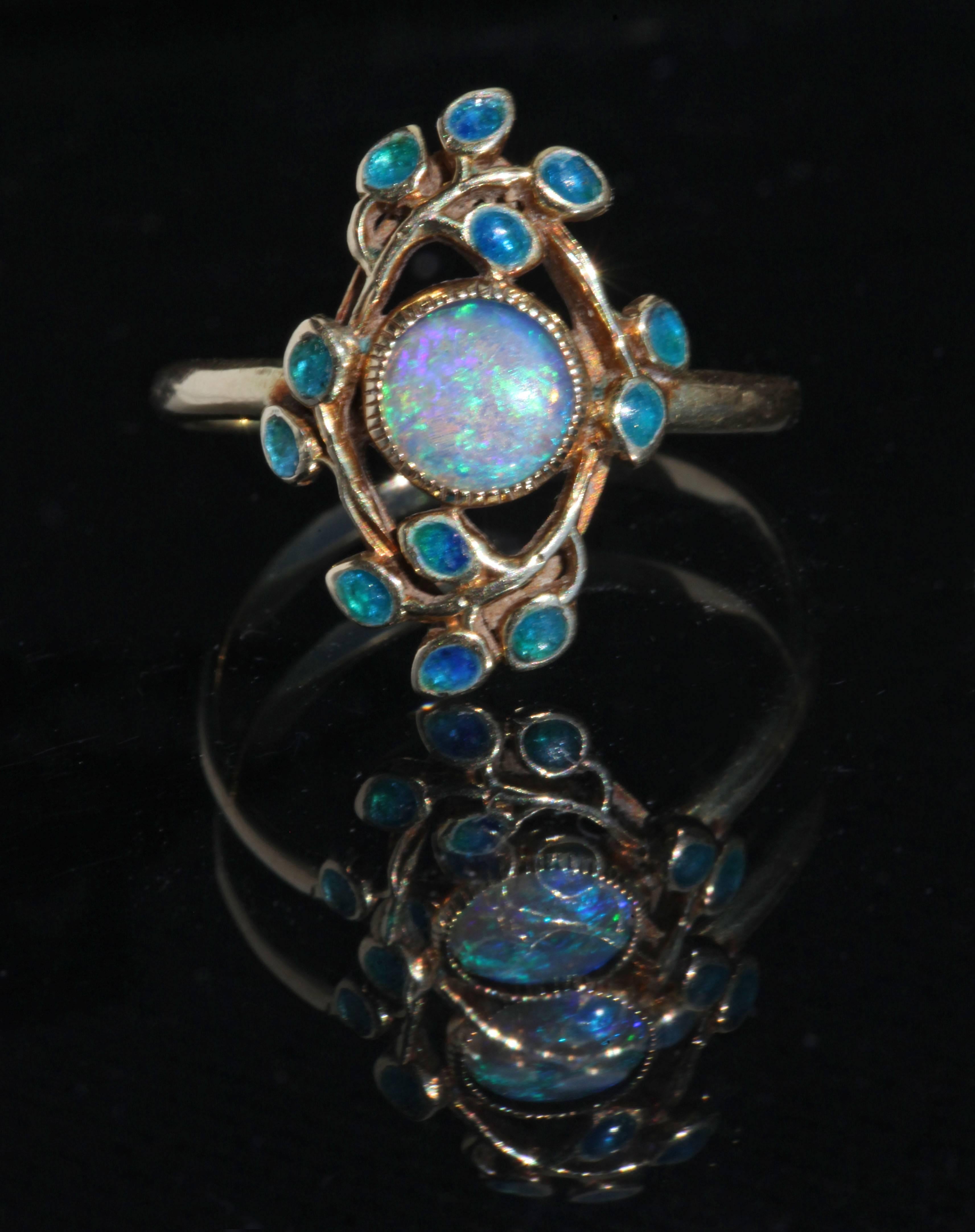 A beautiful Liberty & Co ring designed by Jessie M. King in gold & opal with enameled leaves
Documented Liberty Line Drawings page 73 catalogue number: 4197
Marked: '15ct'
Ring Size UK: O   US: 7.25   EU: 55.1   Asia: 14.5 




